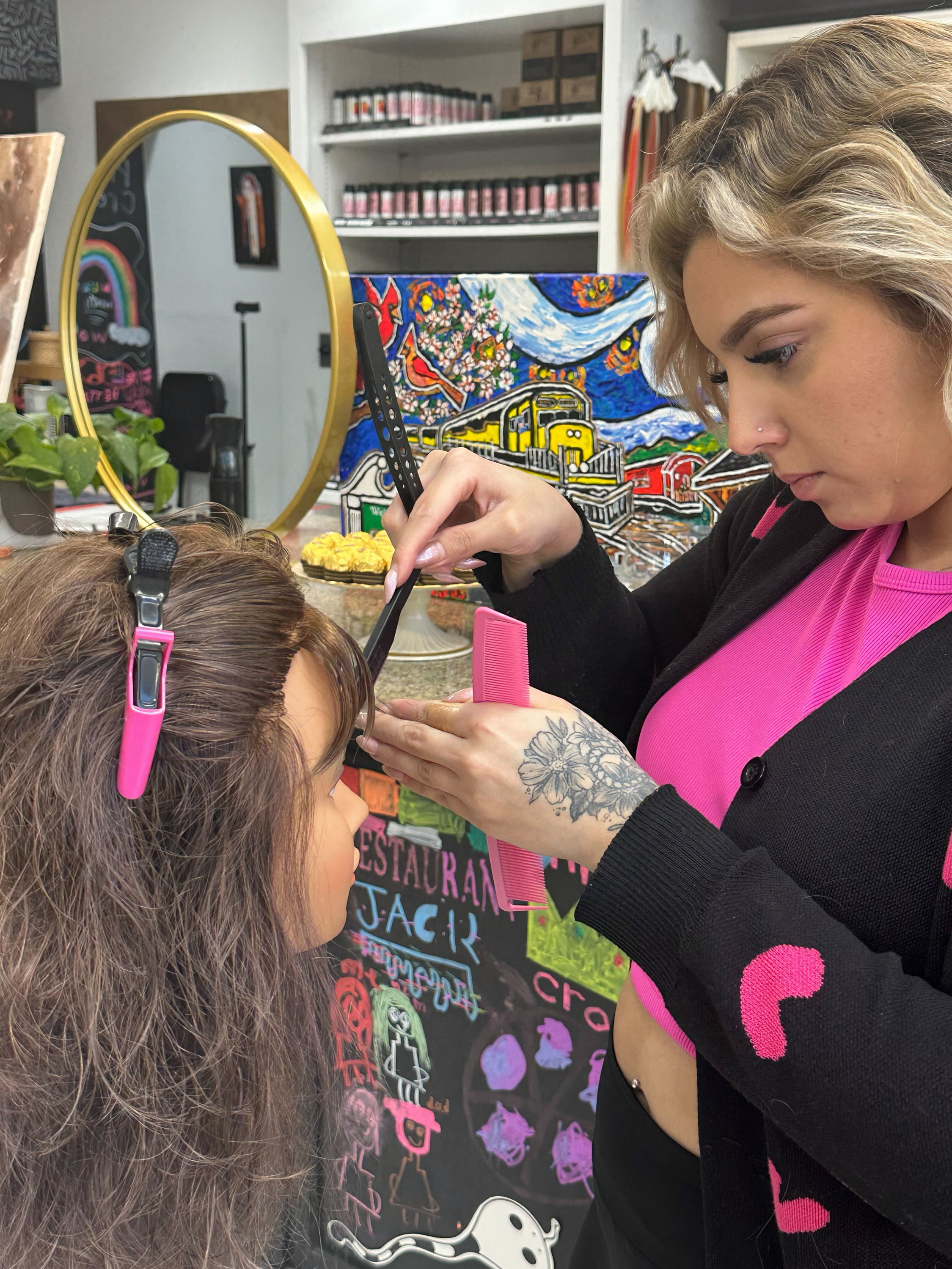 Stylist taking a haircutting education class on advanced razor cutting techniques at Bellibone Salon in Maywood, NJ.