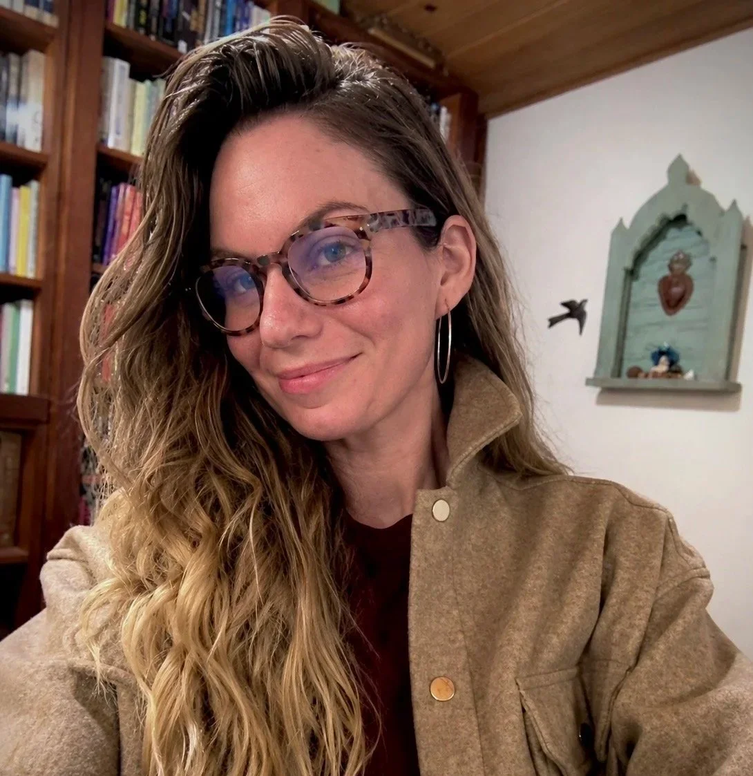 bio picture of somatic coach Kadhi Bo in her home office in front of bookshelf