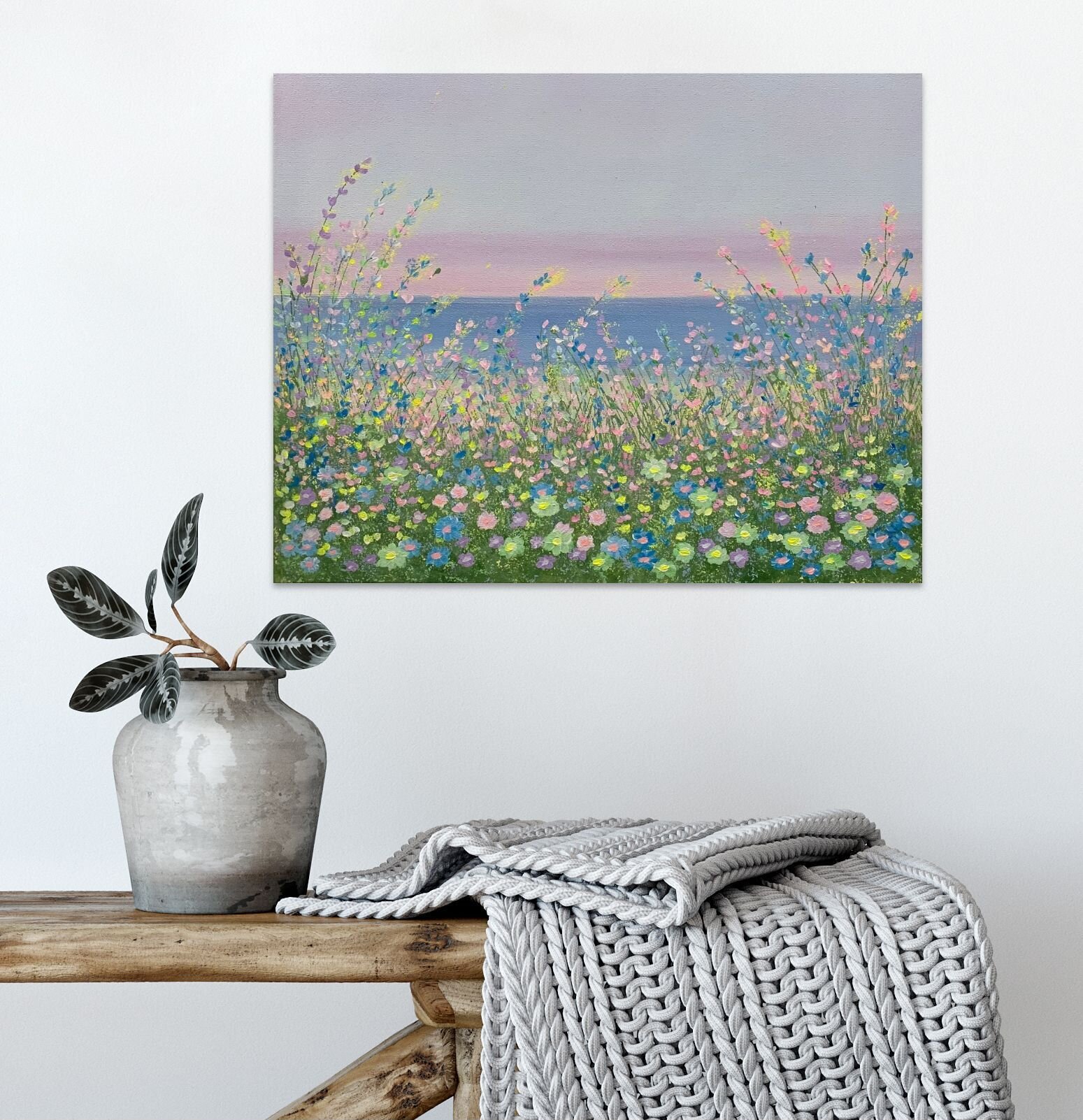 whimsical floral lakeside painting above bench and potted plant.jpg