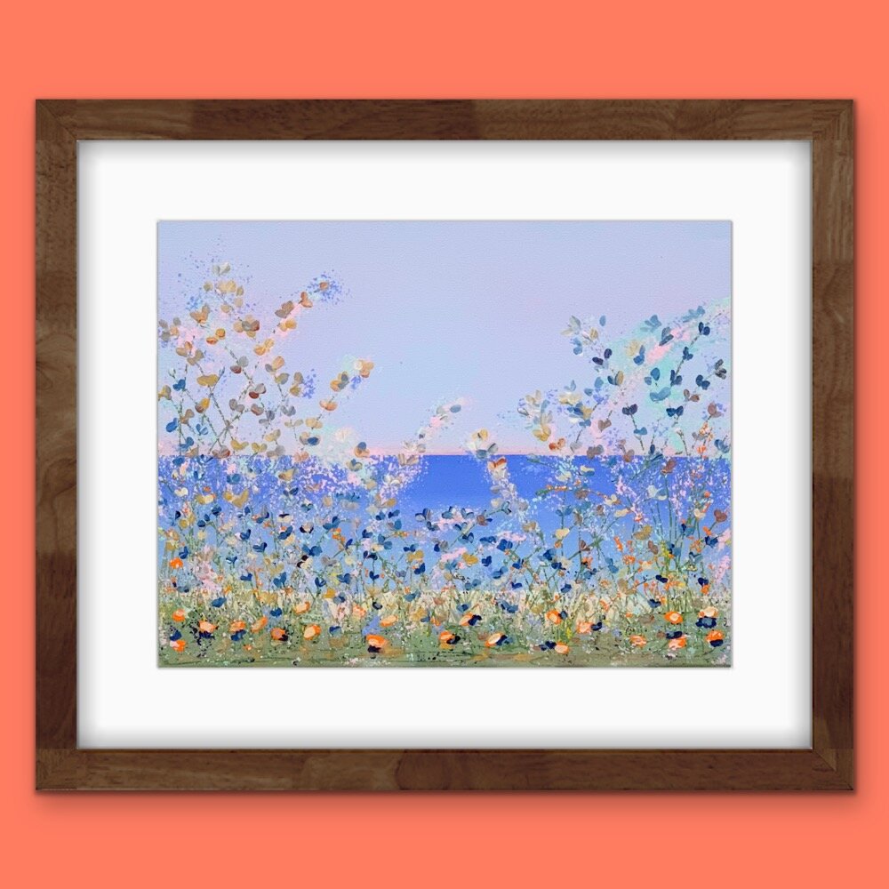 floral lakeside painting with white mat and dark wood frame on orange wall