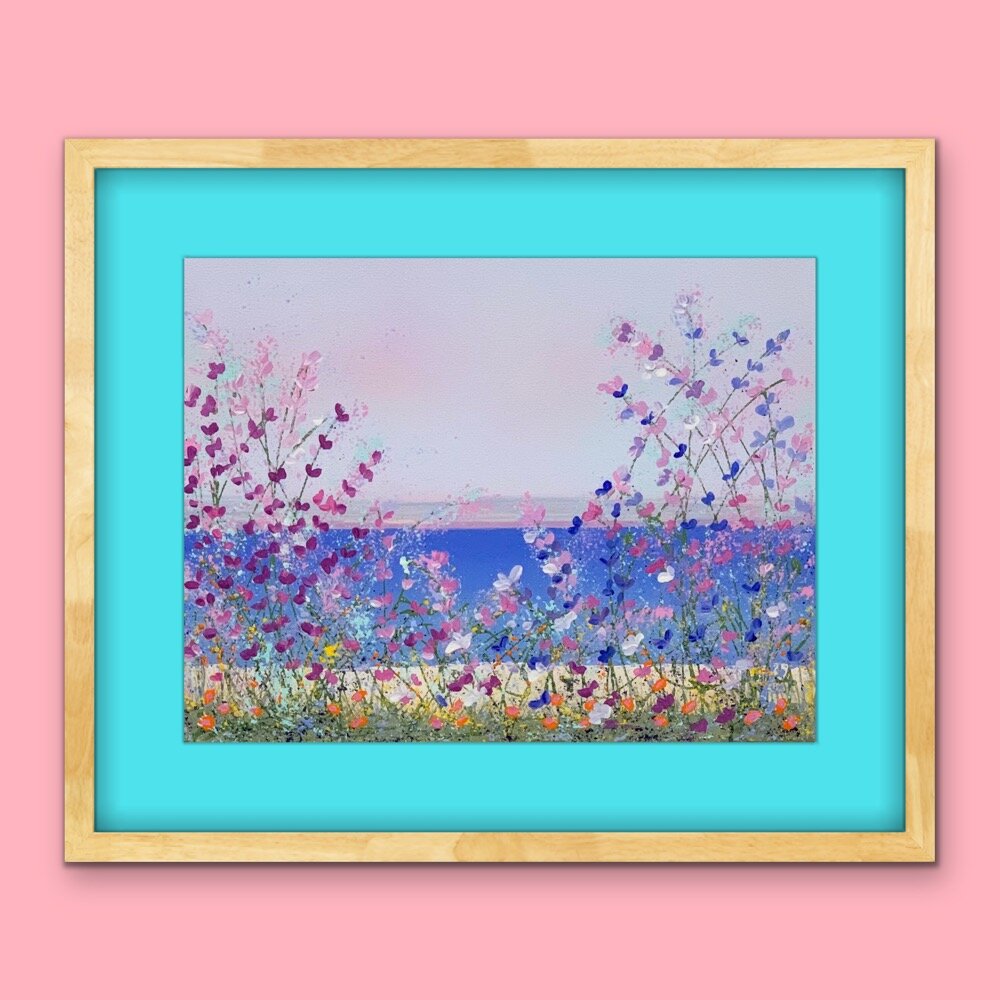 floral lakeside painting with aqua mat and blonde wood frame on pink wall