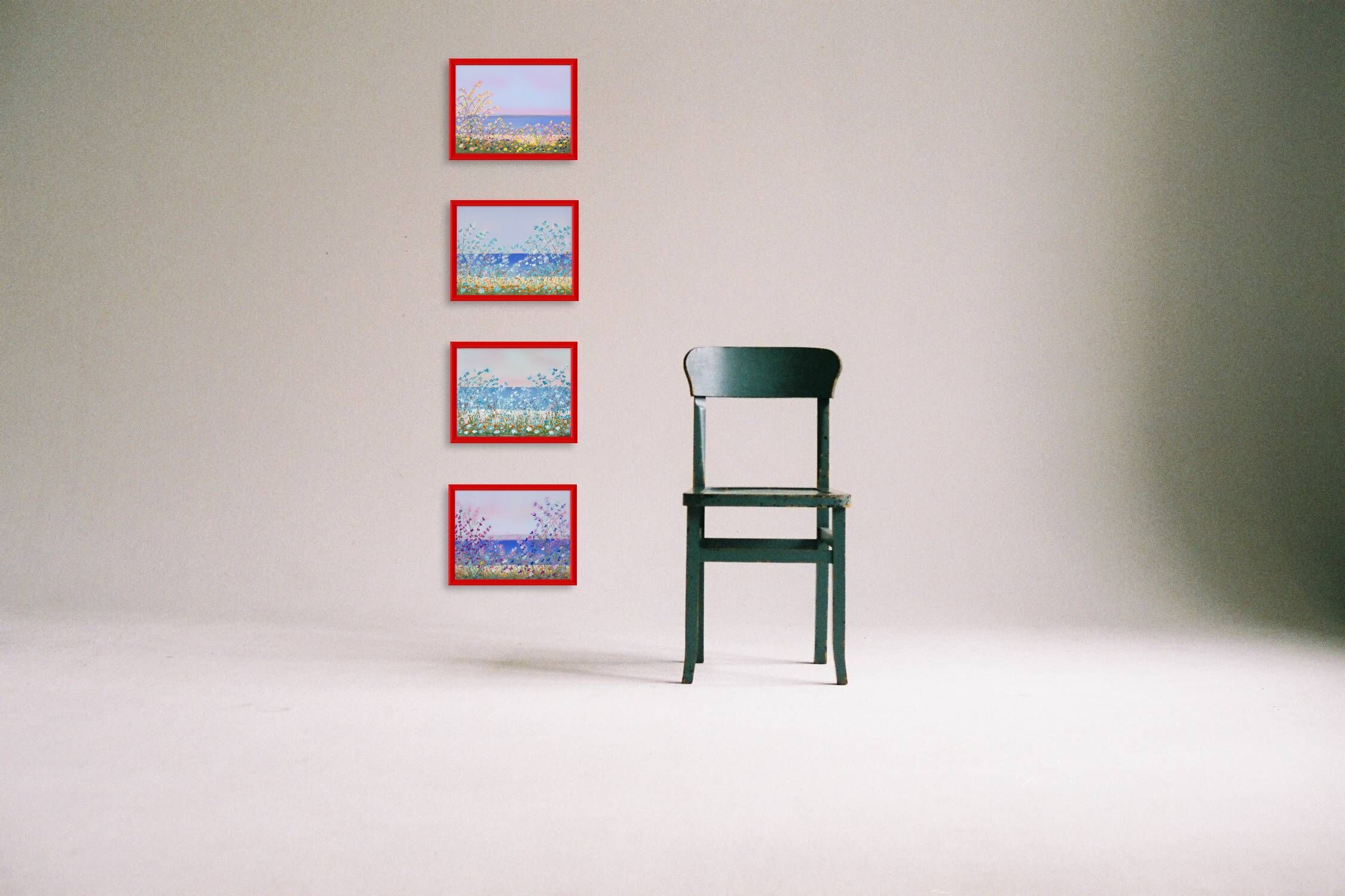 four floral paintings with red frames next to single green chair