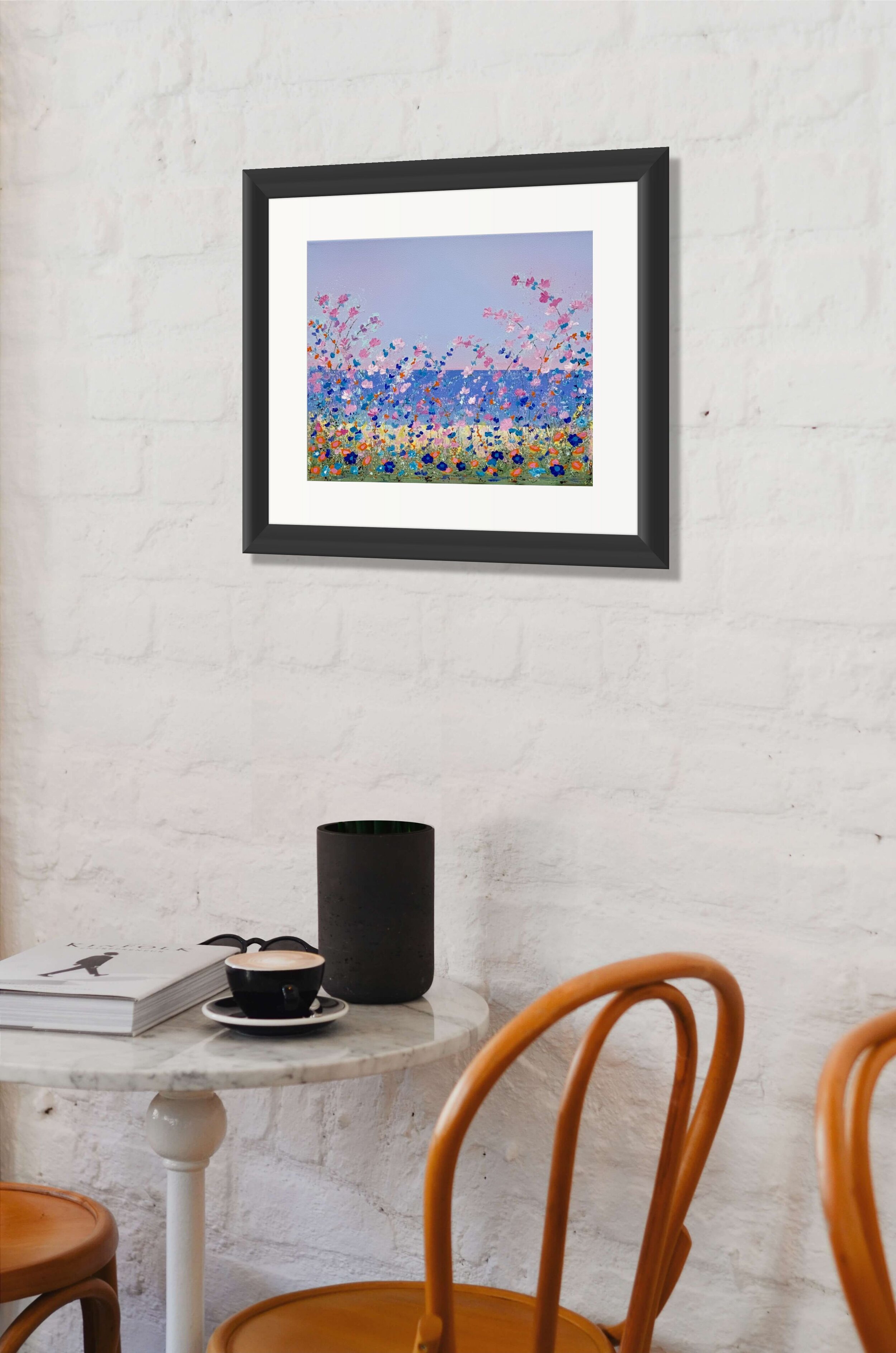 floral painting above coffee shop table and chair