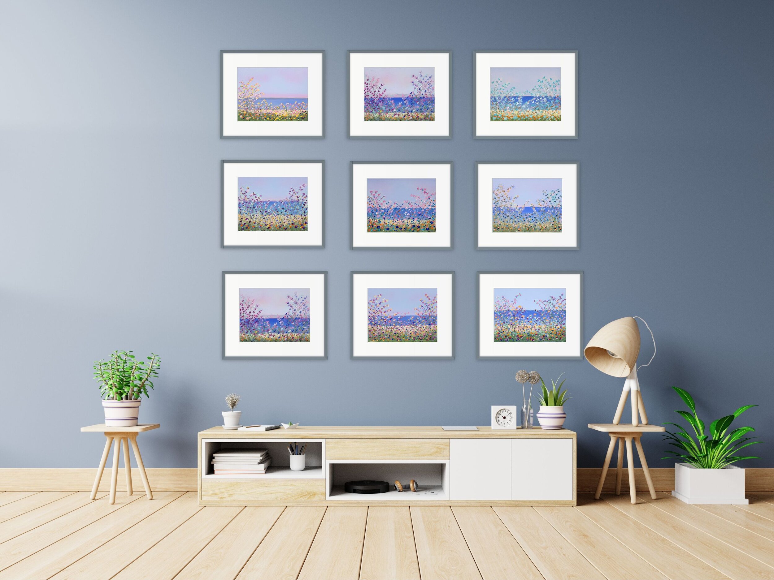 nine paintings on gray wall over low light wood table