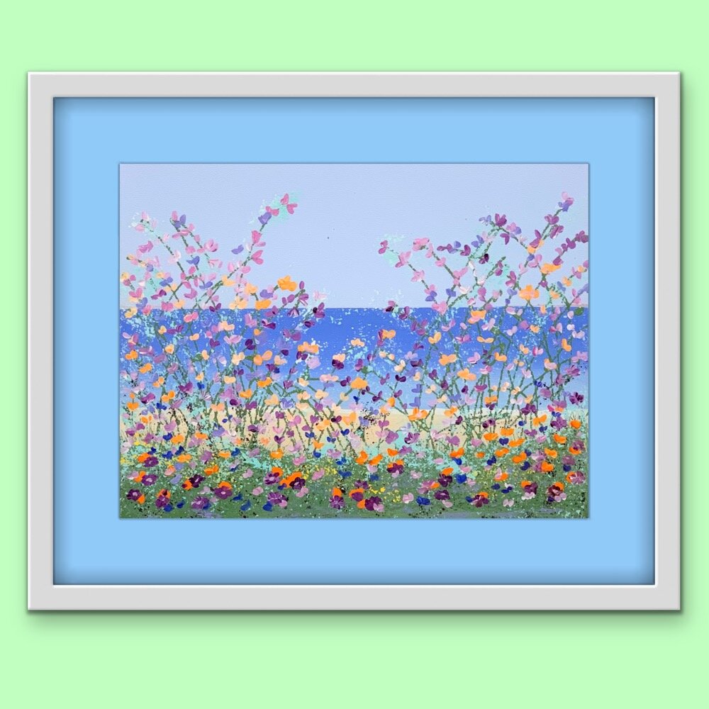 floral lakeside painting with light blue mat and white frame on light green wall