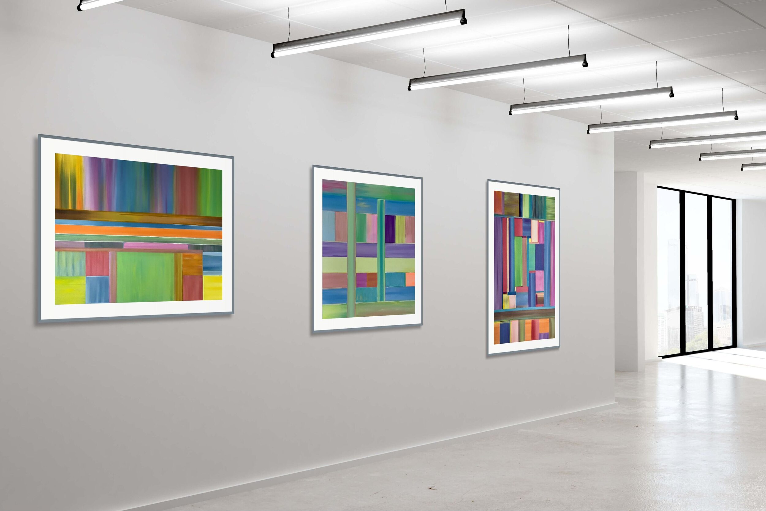 three geometric abstract paintings in gallery hallway