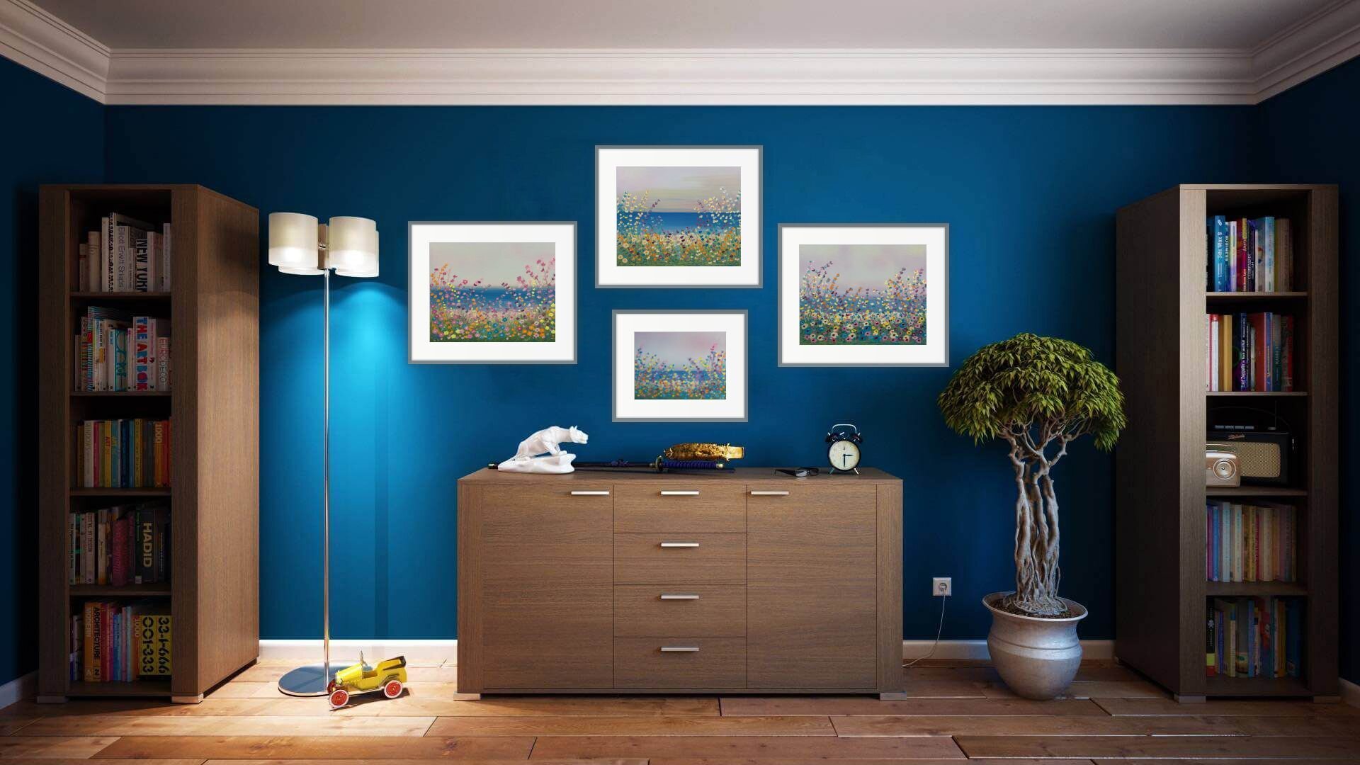 four whimsical floral lakeside paintings in home office with dark blue walls