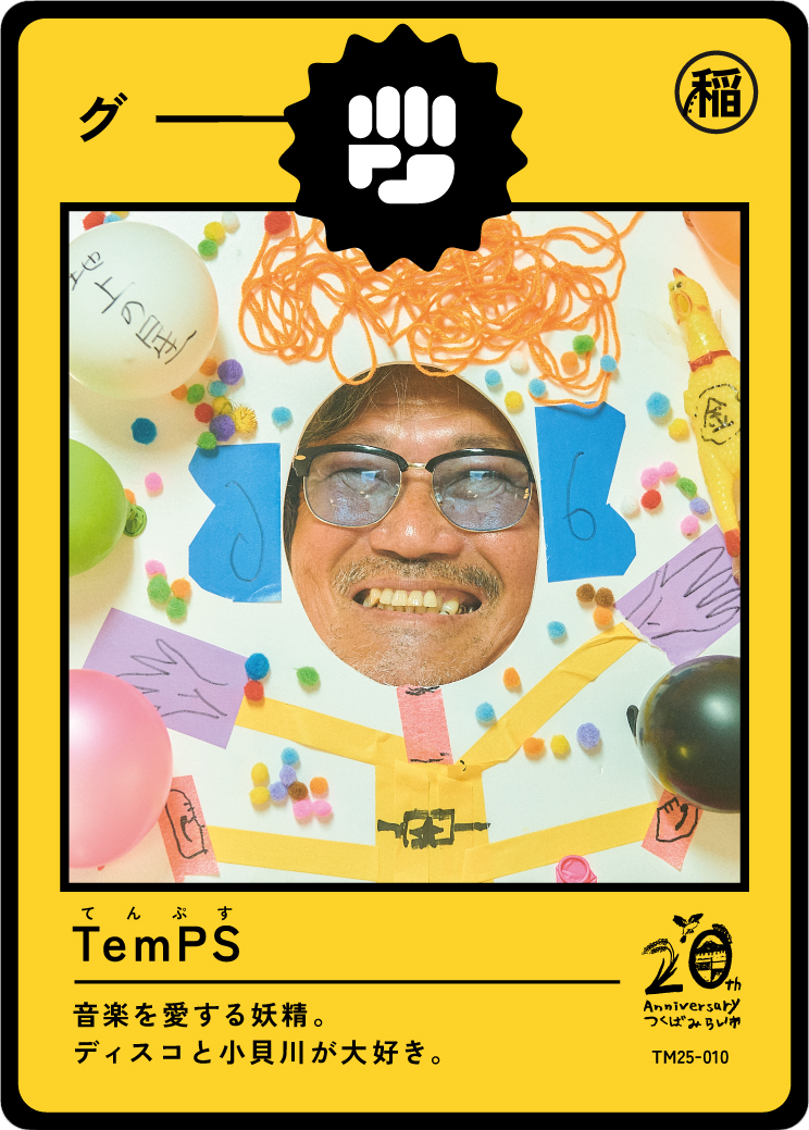 Person with glasses smiling through a decorated paper frame with colorful pom-poms, balloons, and paper cutouts, styled to look like a card or poster for a 20th anniversary celebration.