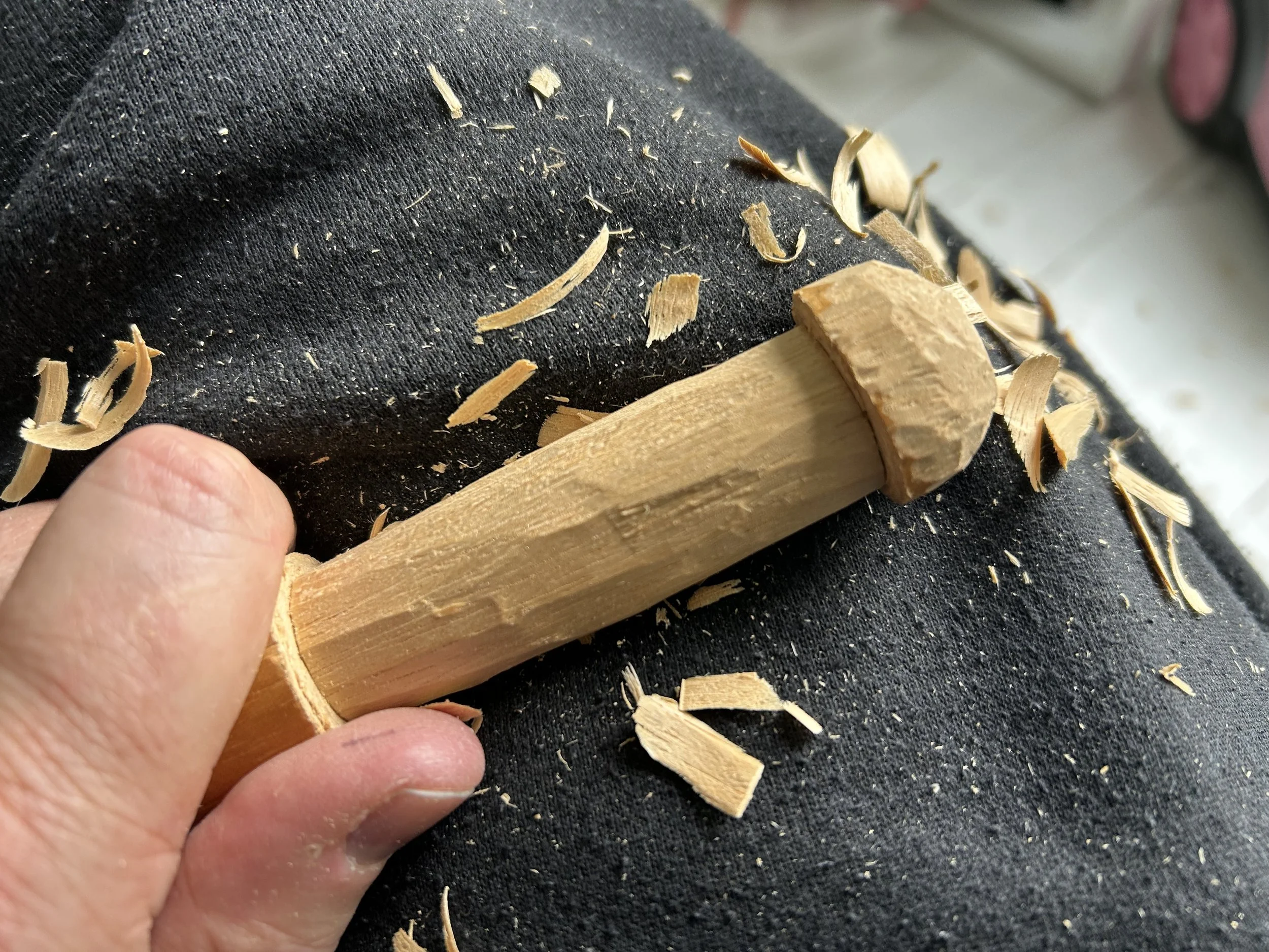Whittling an old curtain pole. 