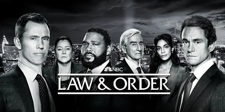 black and white image of season 21 cast of law & order in front of NYC skyline