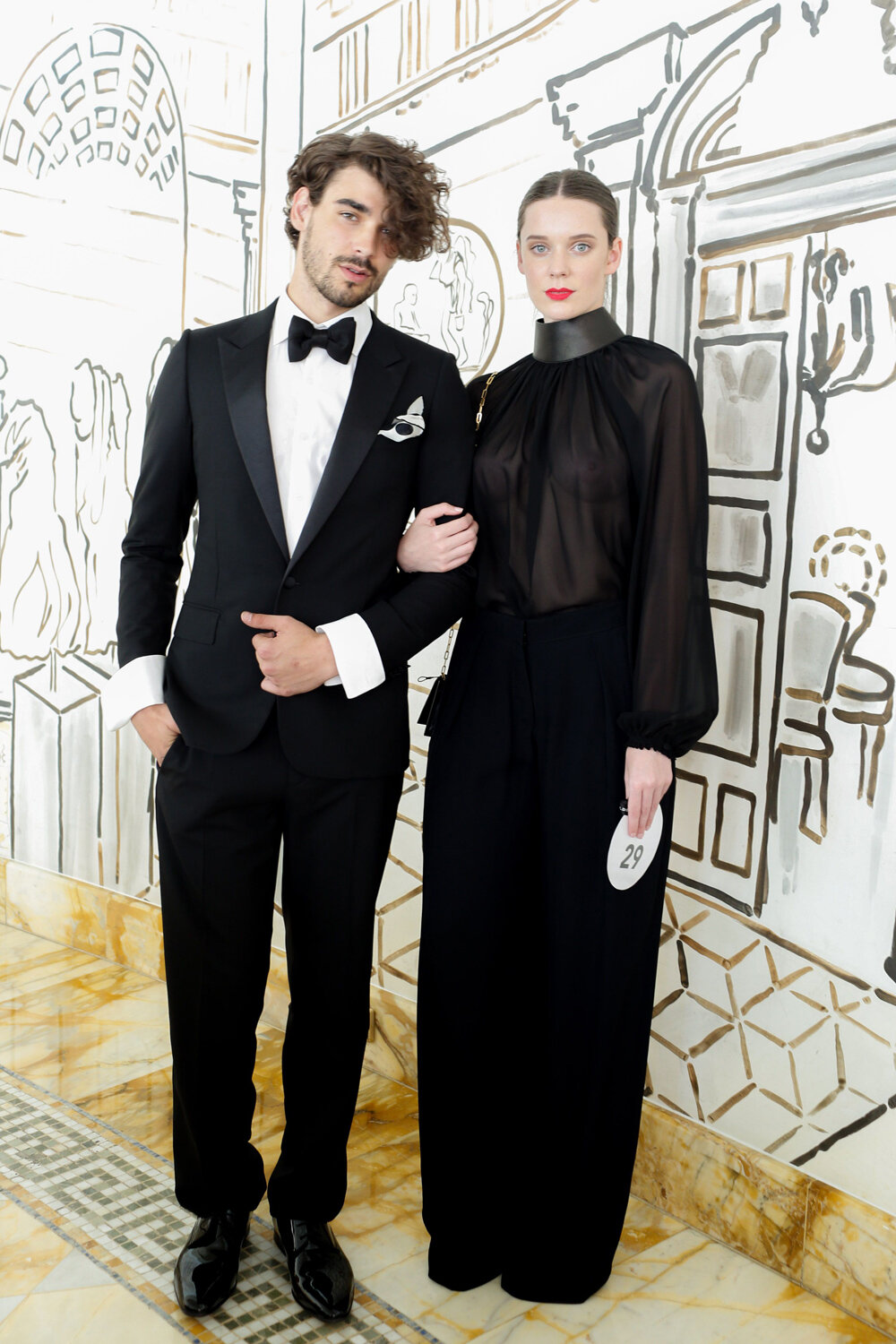 Parade Look 29 Male model wears Harrolds Private Label Suit and female wears Tom Ford