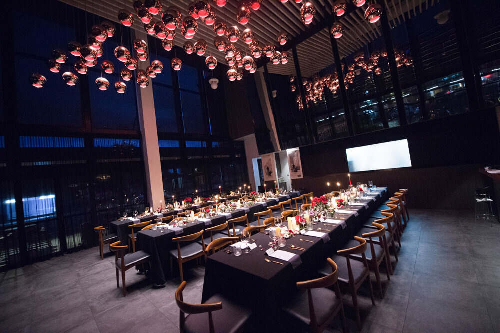 An intimate dinner set under the golden glow of Cicchetti’s rose gold light feature