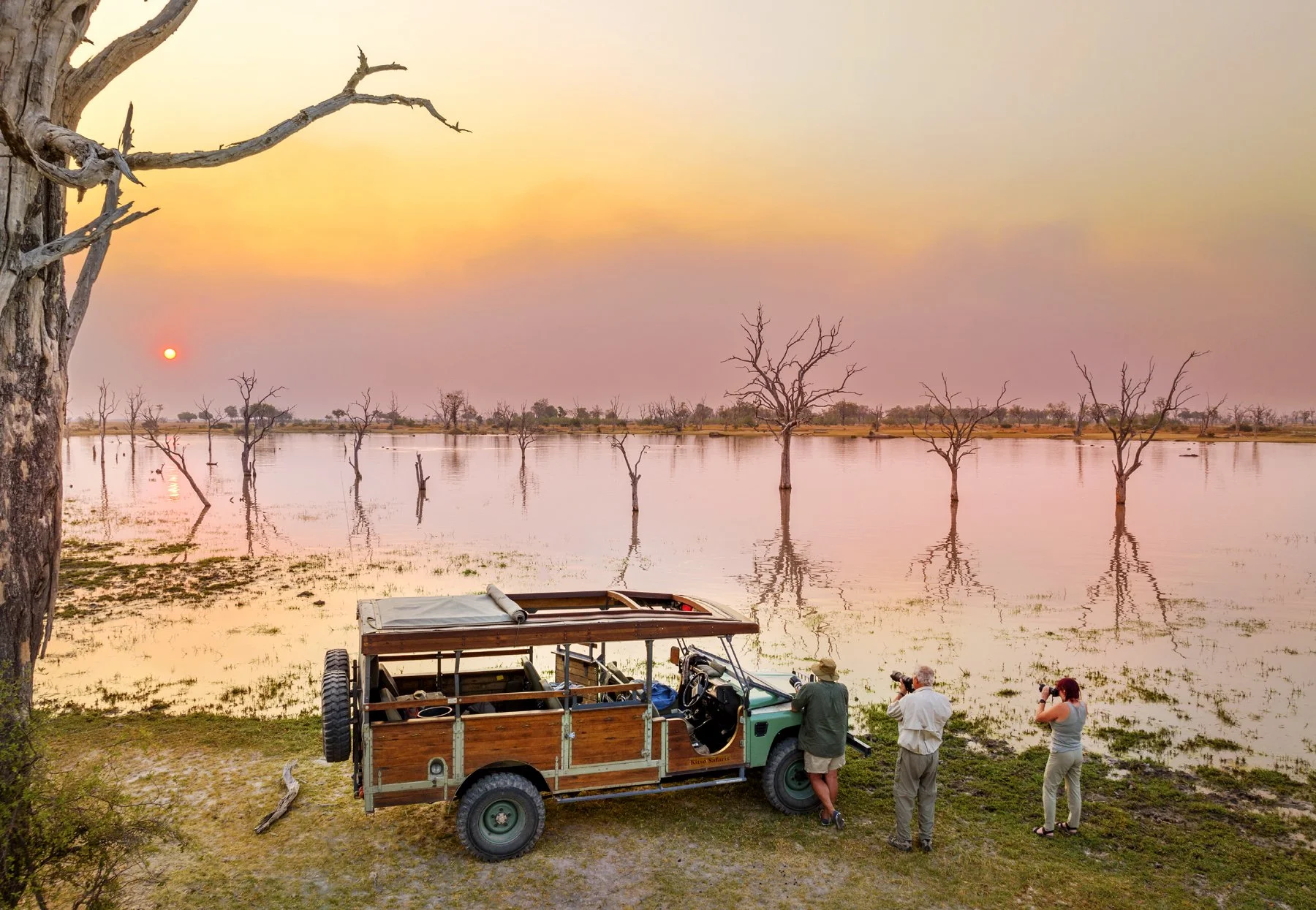 A small group of photographers on a Chris McLennan Africa Photo Safari photographing the sunset.