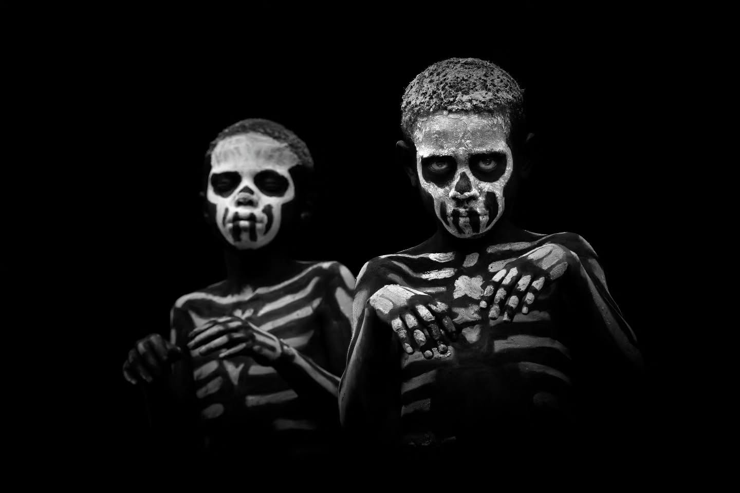 Young boys of the Chimbu skeleton tribe move eerily through the forest, Papua New Guinea.

Whilst the historic use of this body paint was linked to warfare and fear tactics,  today the skeleton tribe adornes themselves this way as a tribute to the hi