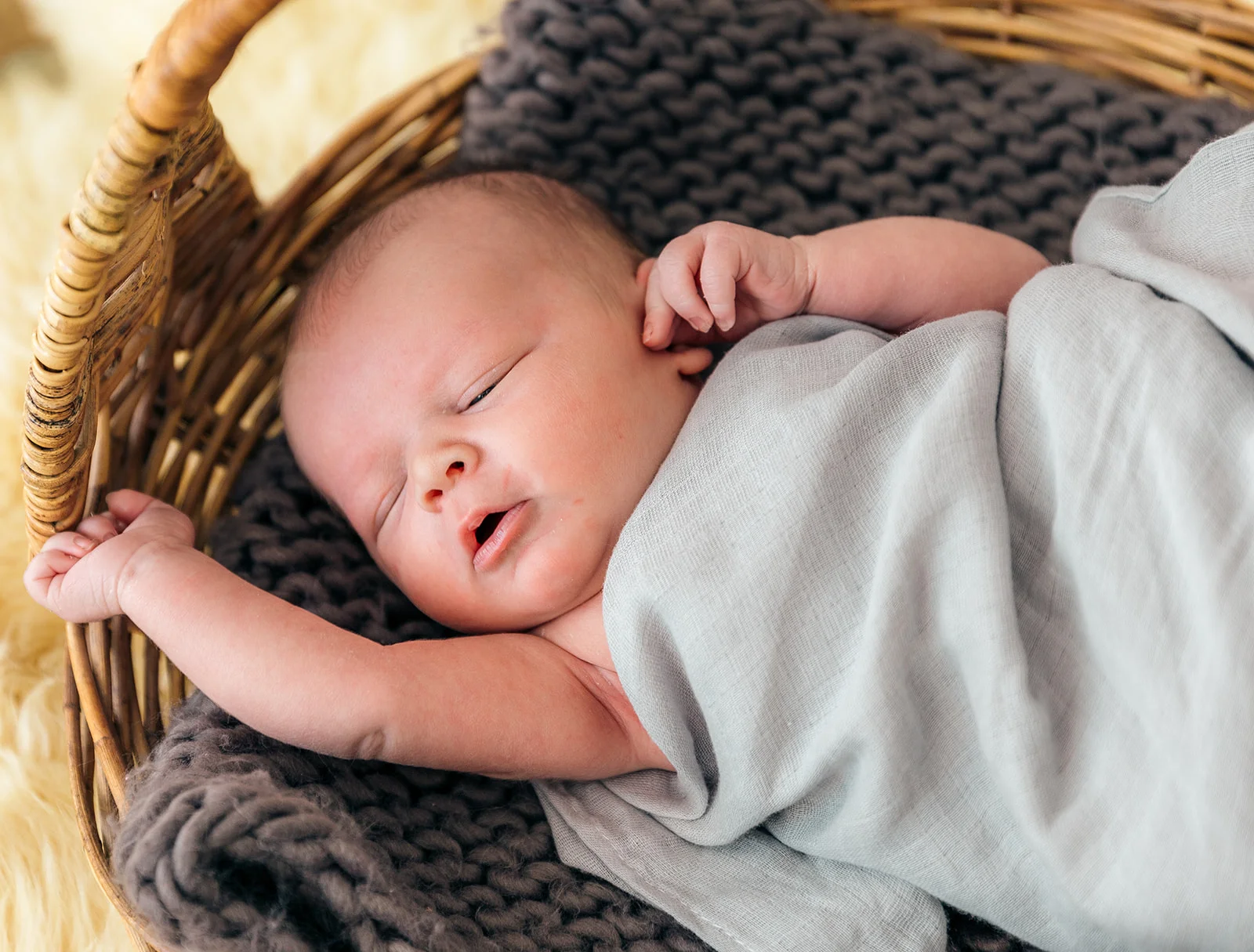 new baby in basket inspiration and ideas wool knit dark grey blanket light grey swaddle blanket baby boy precious baby arms adorable face professional newborn session professional utah photographer bella alder photography handsome baby boy baby beckham newborn #newbornsession #bundleofjoy #babyboy #babyboybeckham #littleangle #familygoals #ogden #utah #professionalphotographer #bellaalderphotography