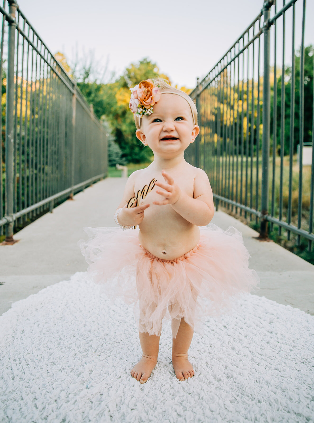  baby posing ideas first birthday baby outfit inspo kids fashion inspo girl power happy face photoshoot props wooden prop inspo small hands holding props one year old turning one pretty girl dancing girl pink tutu baby jewelry kids photographer Logan