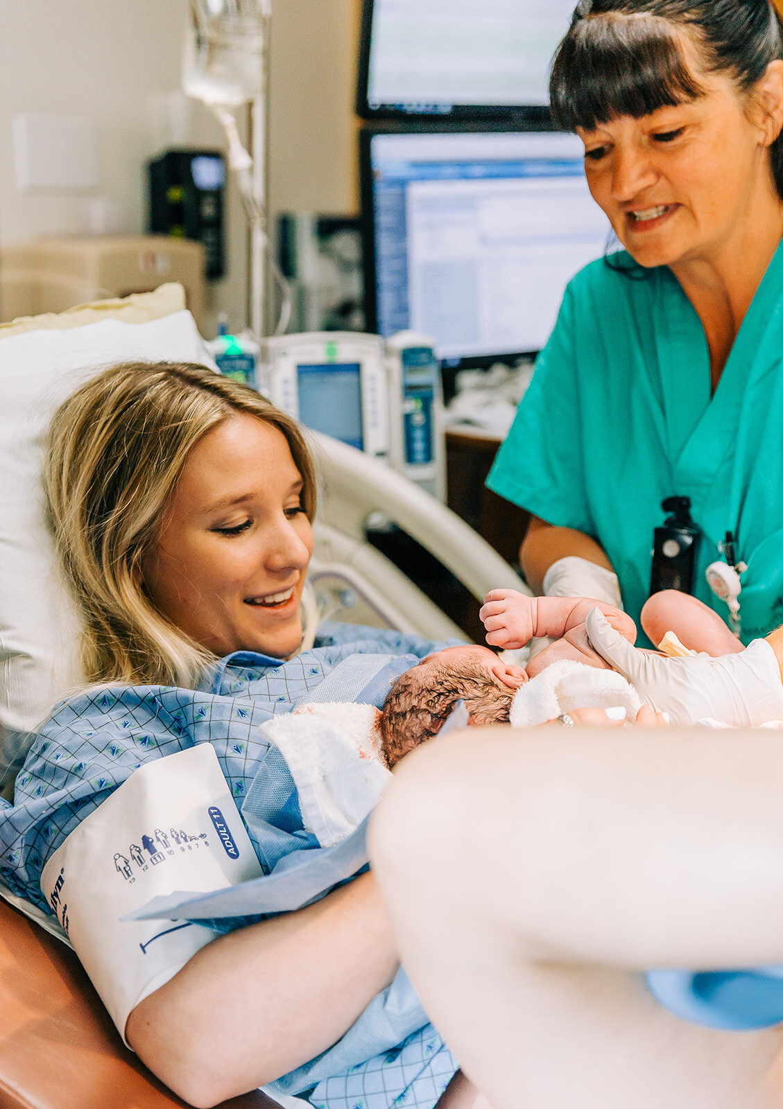  Meeting baby for the first time baby screams newborn baby smooth delivery birth photography first moments together becoming parents mom and dad mom and baby beautiful mom postpartum hospital birth healthy baby healthy mom hospital gown happy moments
