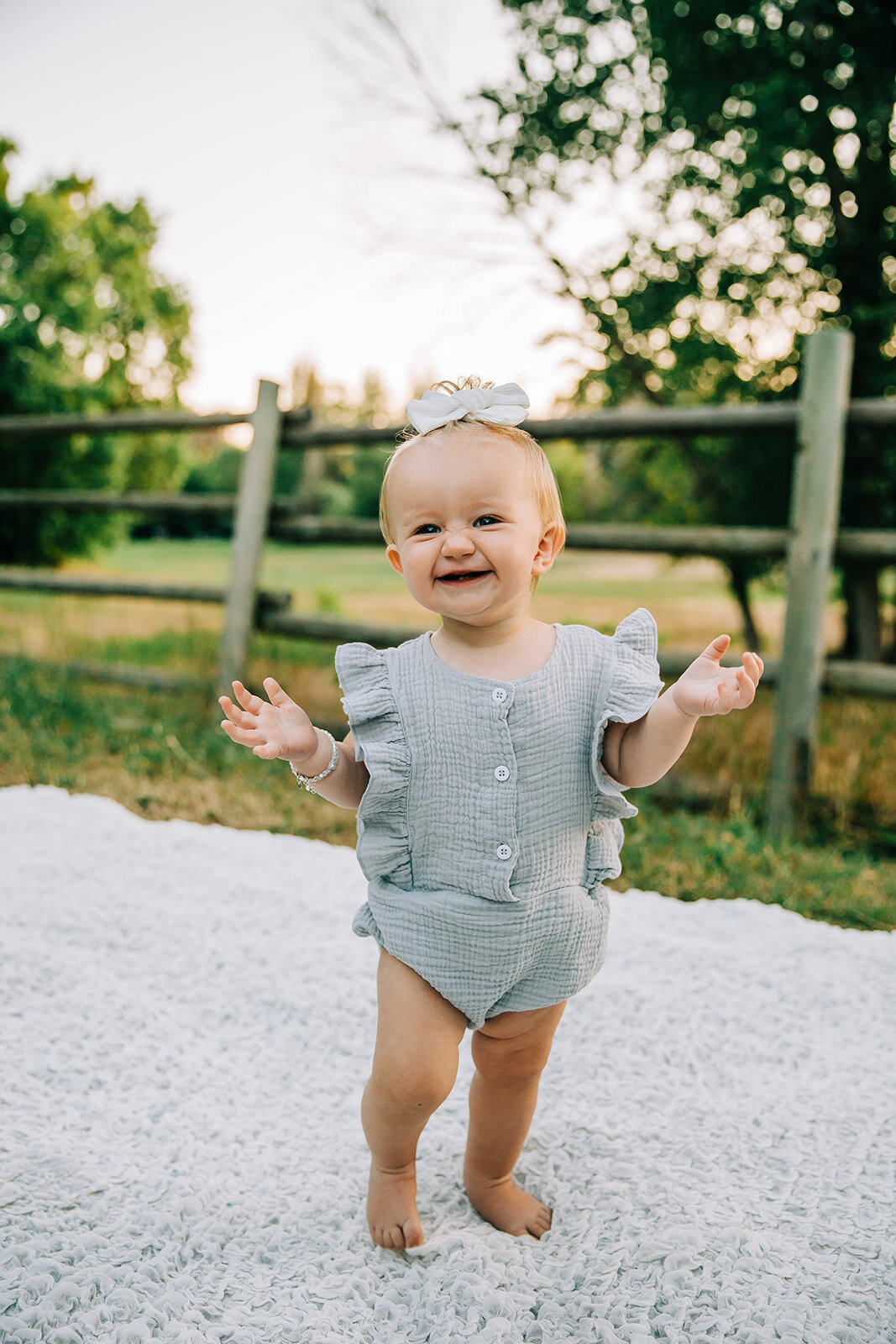  happy girl first birthday birthday photoshoot kids fashion kids style inspo girl fashion inspo girl fancy outfit clothes with buttons hair bows hairdo for baby girls styled hair laughing baby children baby model summer photos pretty park photos cach