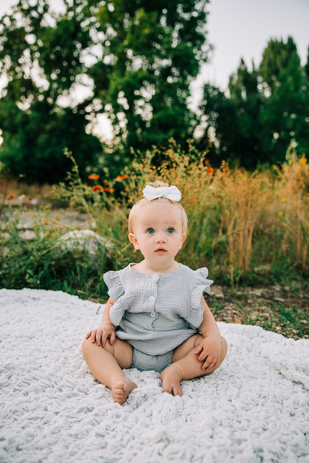  first birthday photoshoot baby girl baby posing inspo sitting down posing ideas kids fashion baby fashion inspo what to wear hair inspo tall grass summer time child model beautiful baby turning one birthday photos milestone birthday cache valley pho
