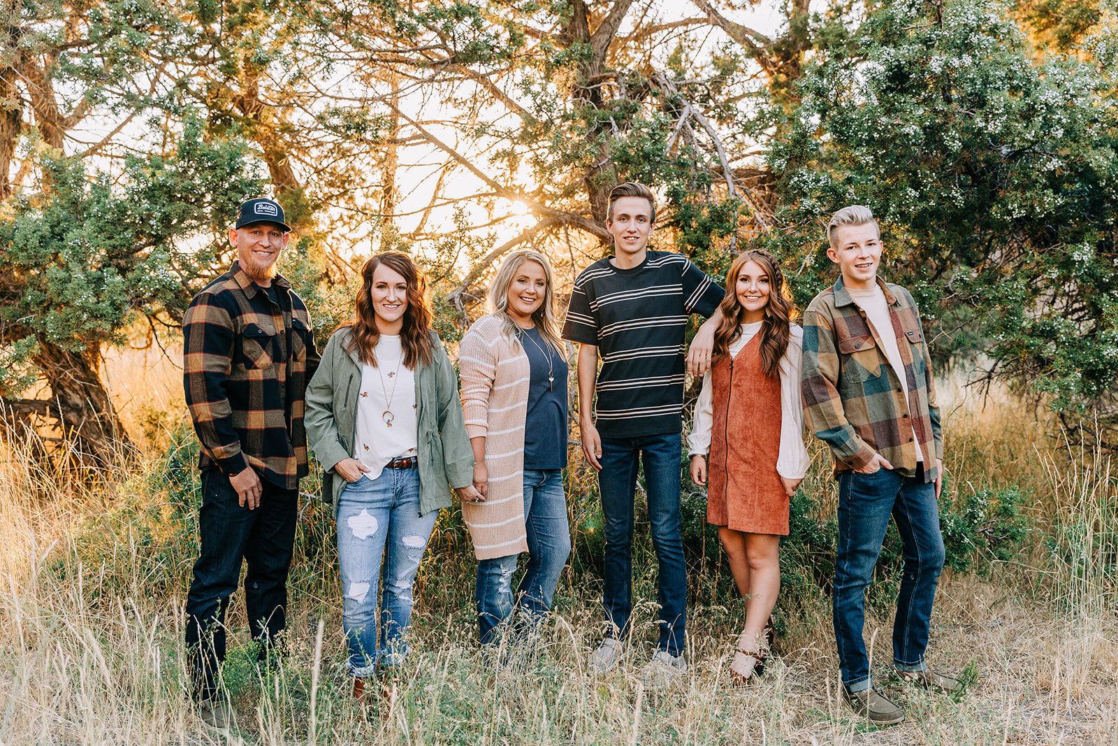  group shot commercial photos for clothing boutique posed photoshoot with multiple models men’s and women’s clothing available online and in tremonton utah at the physical storefront commercial photography by bella alder photography available in cach