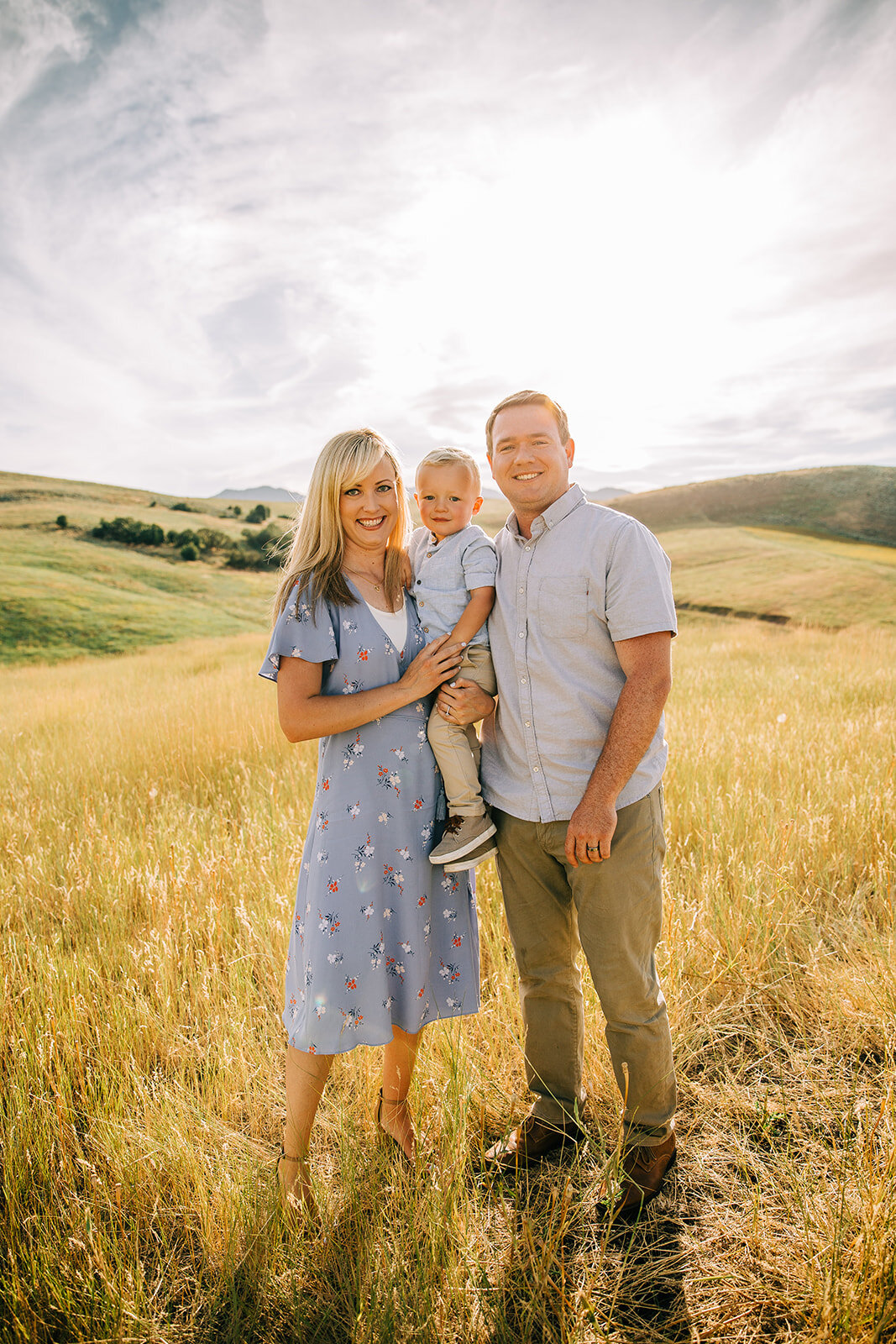  summer family photos blue dress family pictures outfit inspiration yellow fields sunset family picture setting location beautiful paradise utah hyrum utah family photographer bella alder photography cache valley utah family of three posing together 