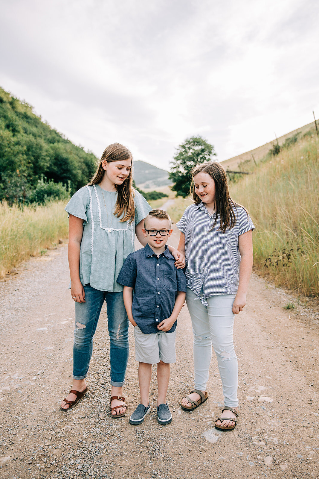  siblings cousins family pictures summertime hyrum utah paradise utah yellow fields family photographer mint blue denim teal outfit coordination family photos outfit color scheme professional family photography by bella alder extended family photos w