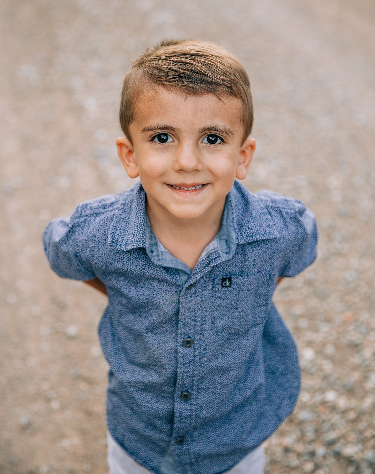  child portraits during family pictures with professional family photographer bella alder photography blue denim button up top young boy looking at the camera individual child photos of each kid during family photo session family pictures cute classy