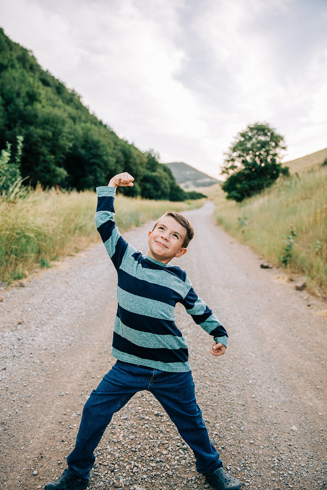  cute young boy super man super strength pose navy and teal stripes professional family pictures with an extended family cousins professional family photos with bella alder photography cache valley family photographer #familypictures #cachevalley #ut