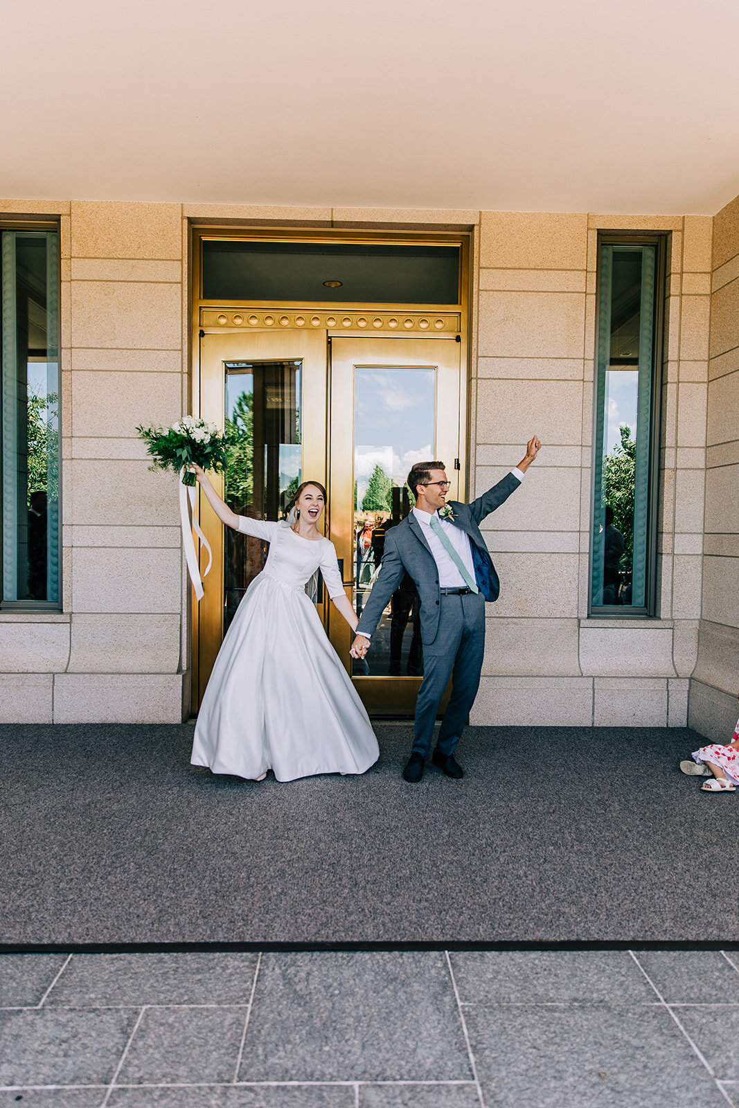  bride and groom exiting the temple cheering exit finally married husband and wife utah wedding utah couples temple wedding walking down the aisle summer wedding inspiration at the oquirrh mountain temple in south jordan utah wedding photographer wed