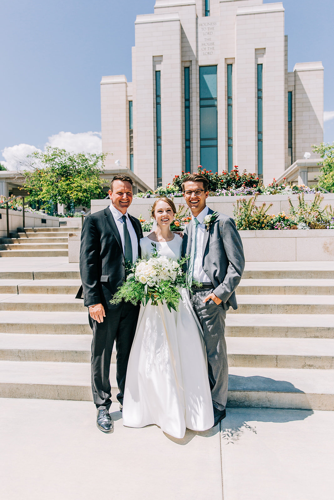  bride and groom posing with father outside the oquirrh mountain temple affordable wedding photographer in salt lake city utah wedding pictures professional photographer bella alder photography available for travel mormon wedding utah couples salt la