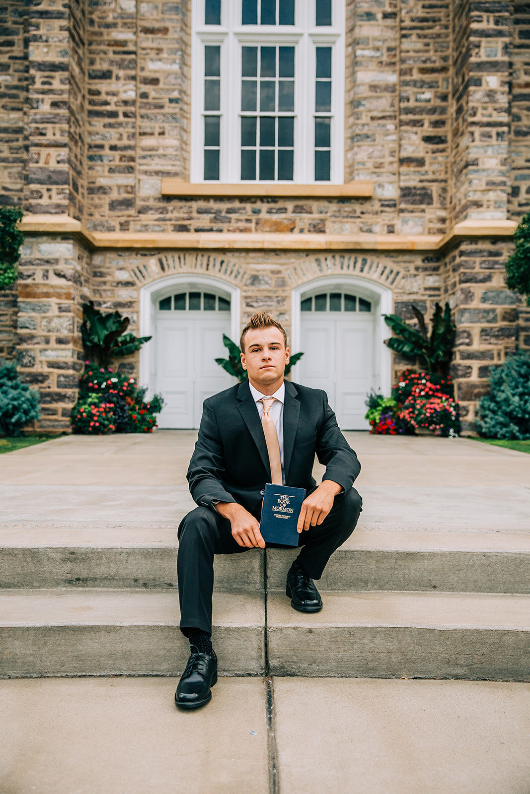  missionary portraits professional photos senior pictures affordable photos of young missionary elder holding a book of mormon on the steps outside the temple logan utah professional photographer missionary headshots cache valley missionaries #bellaa