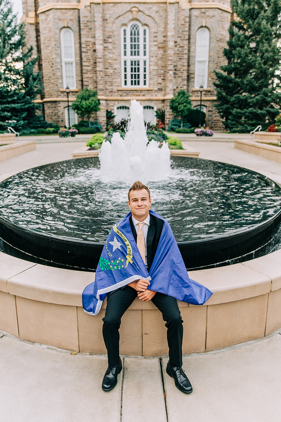  las vegas nevada missionary state flag for nevada missionary photos at the temple logan utah sitting at the fountain black suit called to serve lds missionary headshots professional portraits of a new elder bella alder photography #bellaalderphoto #