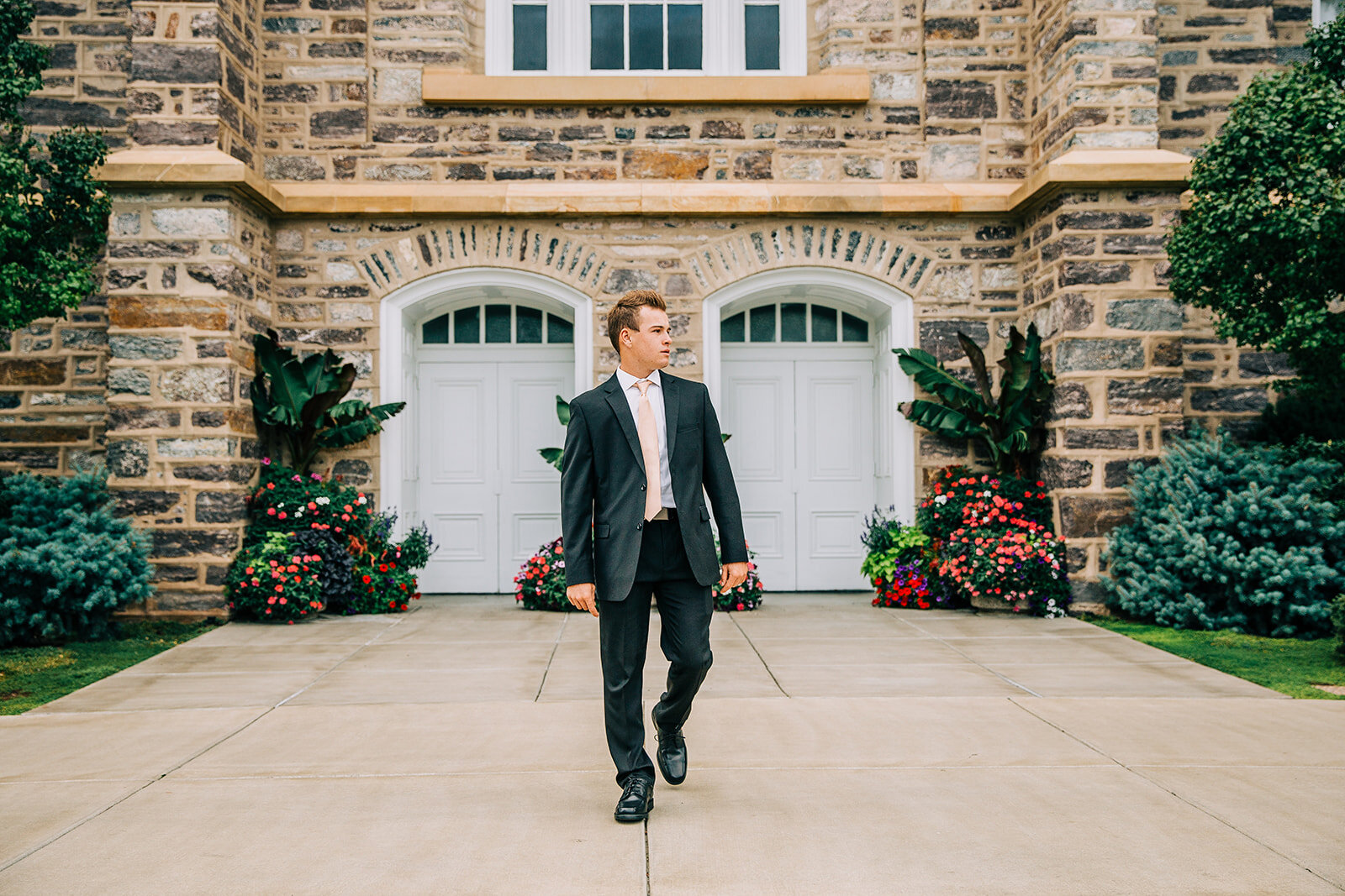  professional missionary pictures in cache valley young man black suit walking towards camera looking away pose ideas senior portraits missionary photo session at the logan utah temple #bellaalderphoto #missionary #missionaryportraits #missionpics #m