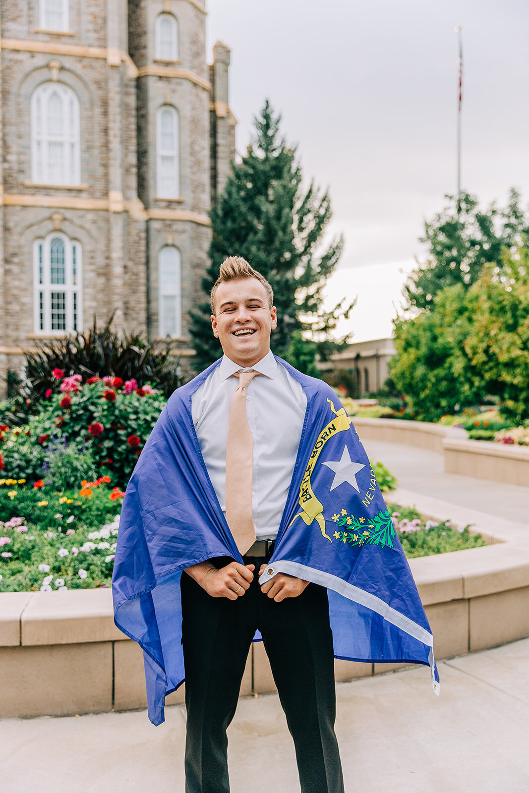  young missionary laughing holding nevada state flagged called to las vegas nevada mission logan utah temple pictures missionary portraits professional cache valley photographer bella alder photography #bellaalderphoto #missionary #missionaryportrait