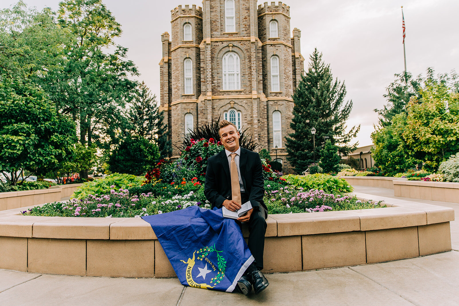  young man missionary reading his scriptures book of mormon stories logan utah temple nevada state flag prop for missionary photos ideas for poses professional missionary portraits cache valley utah #bellaalderphoto #missionary #missionaryportraits #