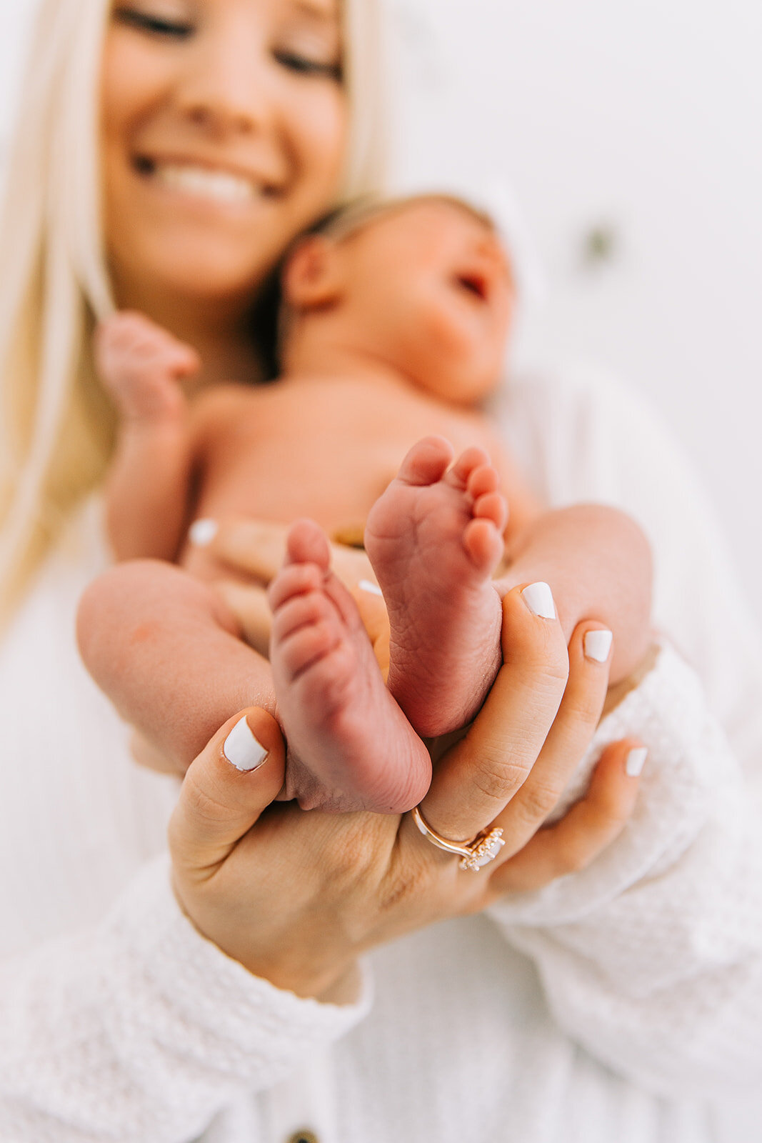  adorable pose idea to get a shot of newborn baby tiny feet baby girl newborns blush door studio mom in a white shirt naked baby pose family photos natural light studio logan utah newborn photographer bella alder photography available for travel prof