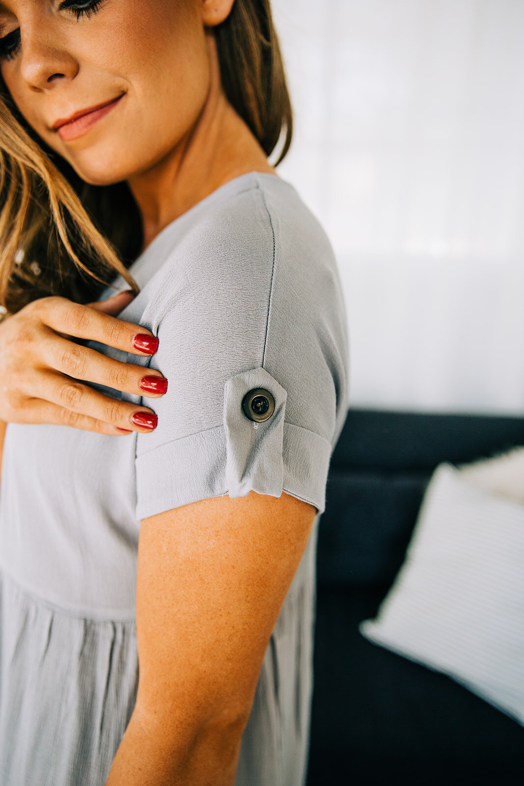  detail of sleeves on short sleeve grey dress model sleeve detail large button strape holding up dress sleeve short sleeves fall inventory online clothing boutique new products modest fashion boutique located in logan utah inventory photo shoot by pr