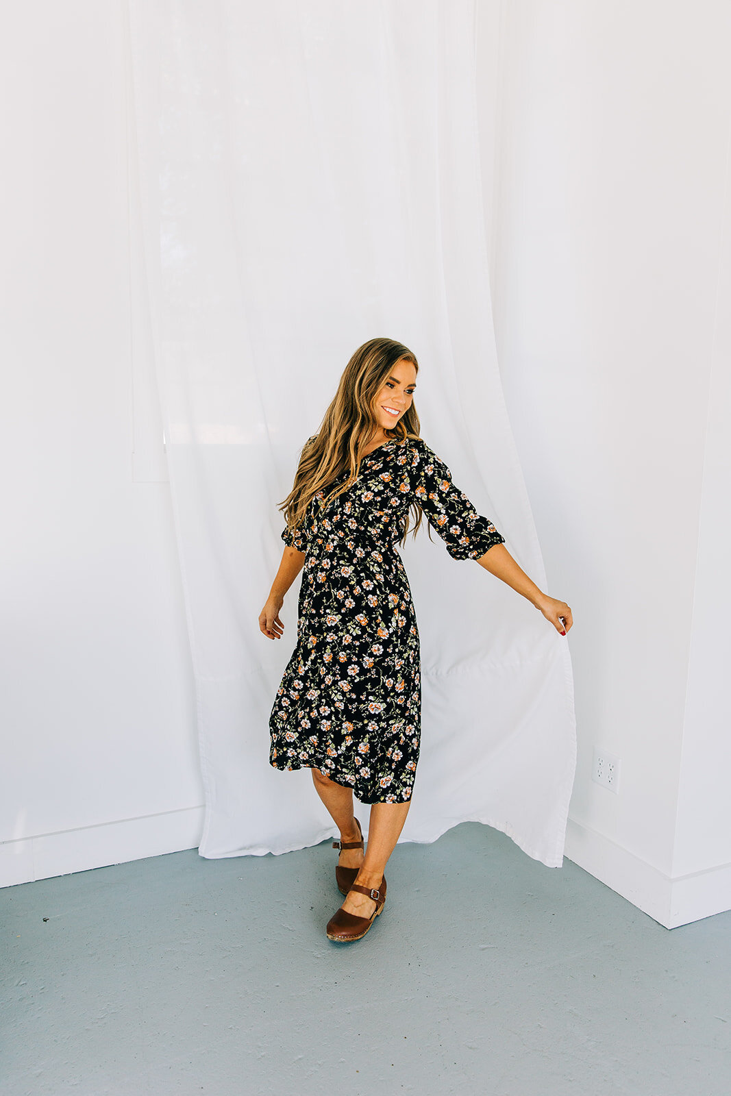  online clothing boutique women’s fashion black boho dress with small flower details product photography clothing photo shoot in station studio river heights utah white backdrop natural light studio professional product photography bella alder photog