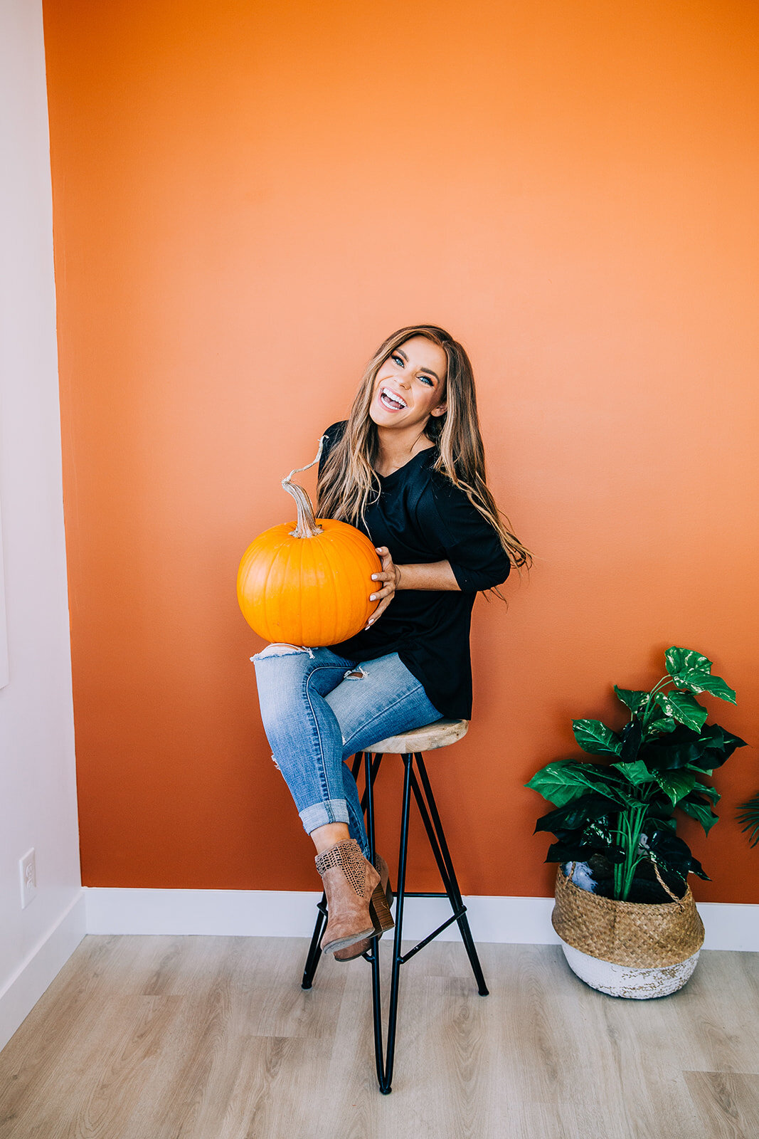  fall product photos new inventory posing with a pumpkin against a coral wall station studio natural light studio in river heights utah logan utah product photography commercial photographer bella alder modest fashion boutique online inventory fall l