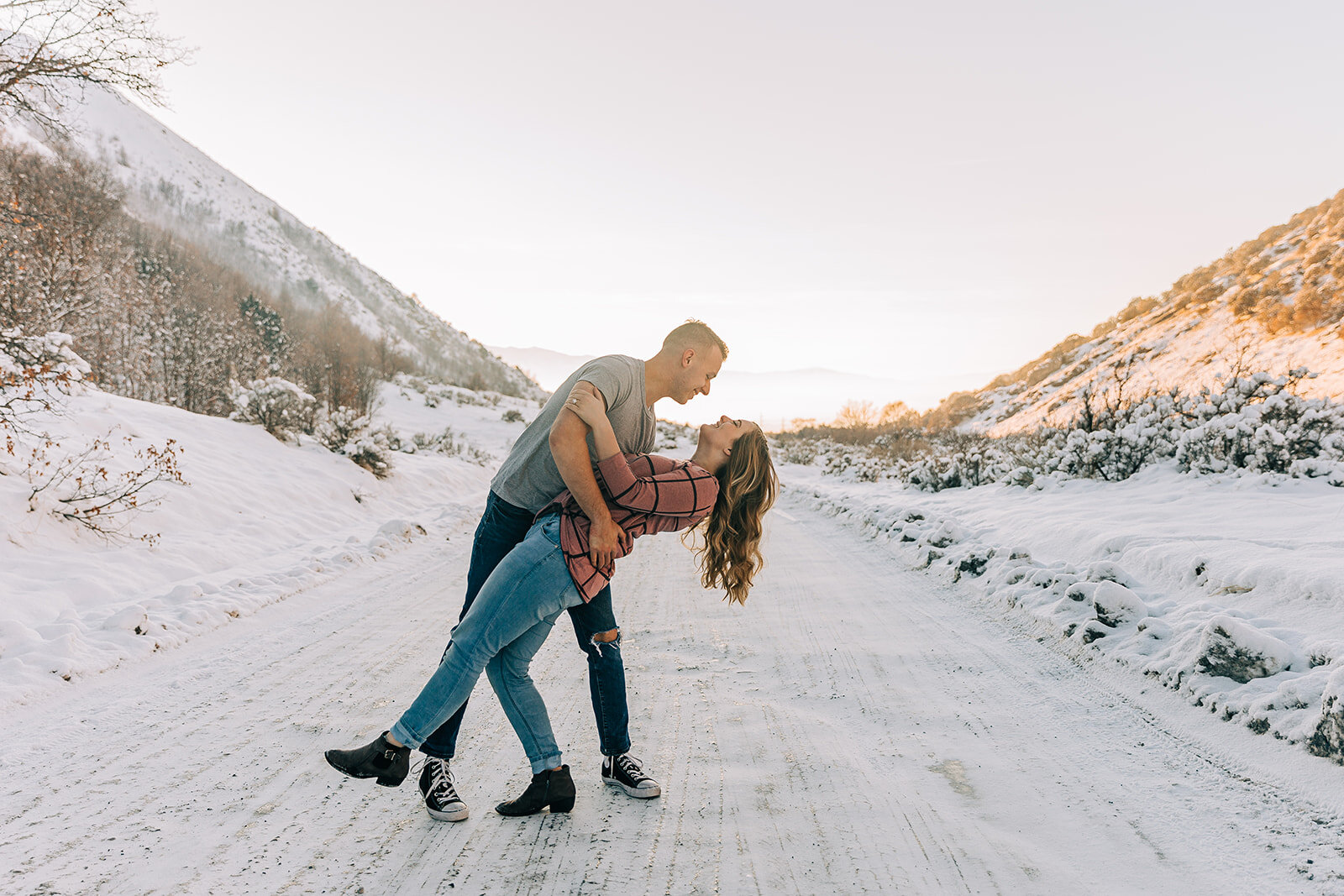 Portrait Of Smiling Happy Couple Together With Friends On Winter Walk In  Snowy Forest. Loving Couple Or Couple Of Best Friends Pose Together Against  Background Of Cheerful Young People Running In Snow