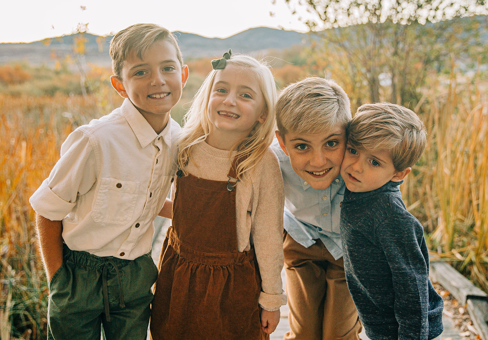  smiling siblings three sons one daughter family pictures garden city park bear lake utah together again fields of gold mountains lakeside photos professional photographers in utah utah family photographers extended family siblings families are forev