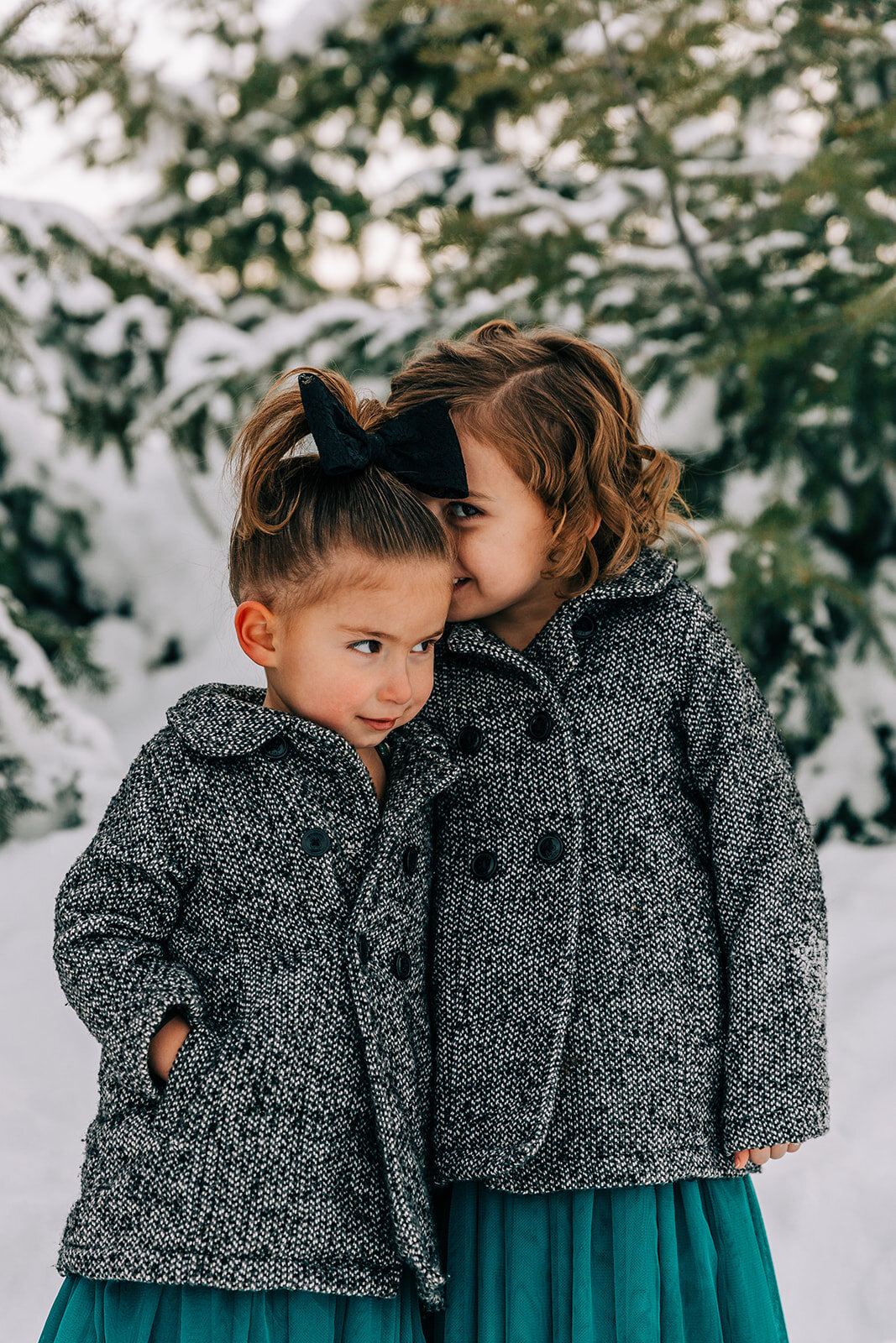  sisters in matching coats and dresses sister love best friends winter fashion family pictures daughters family picture styling inspiration family pose ideas winter photoshoot snowy pictures adams acres tree farm family photographers in utah professi