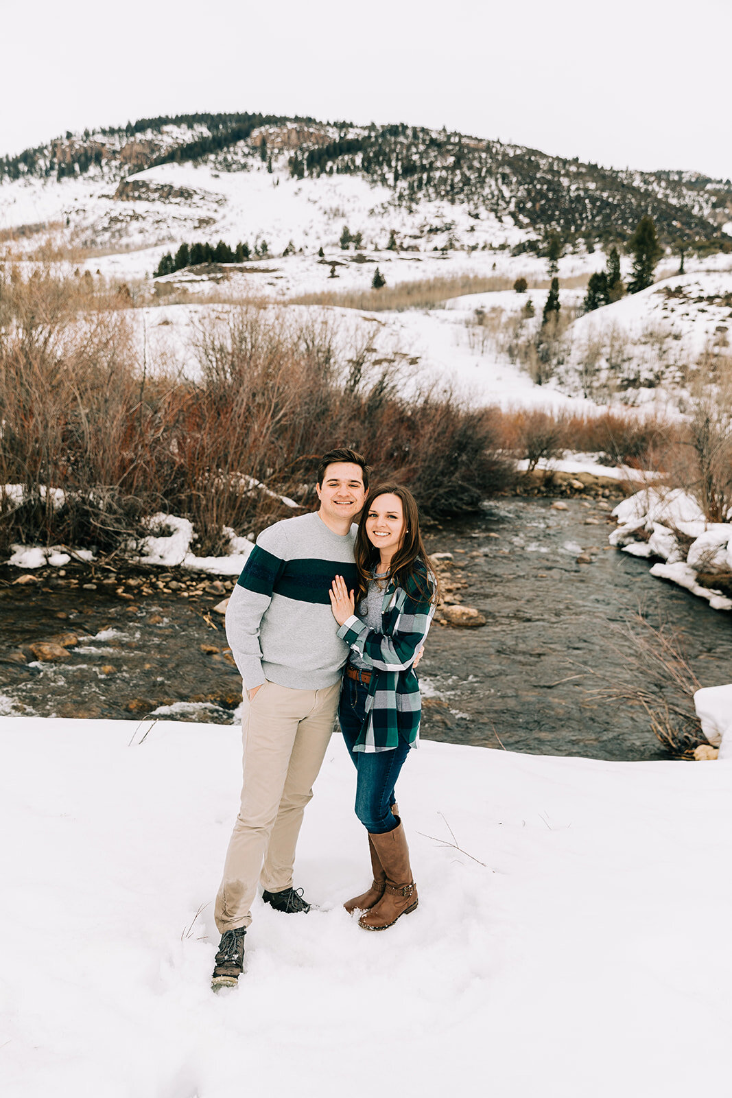  winter engagement session in tony’s grove logan canyon winter engagement session attire casual men and women winter attire for outdoor photo shoot session grey and blue outfit inspiration women hairstyle inspiration for engagement sessions logan cou