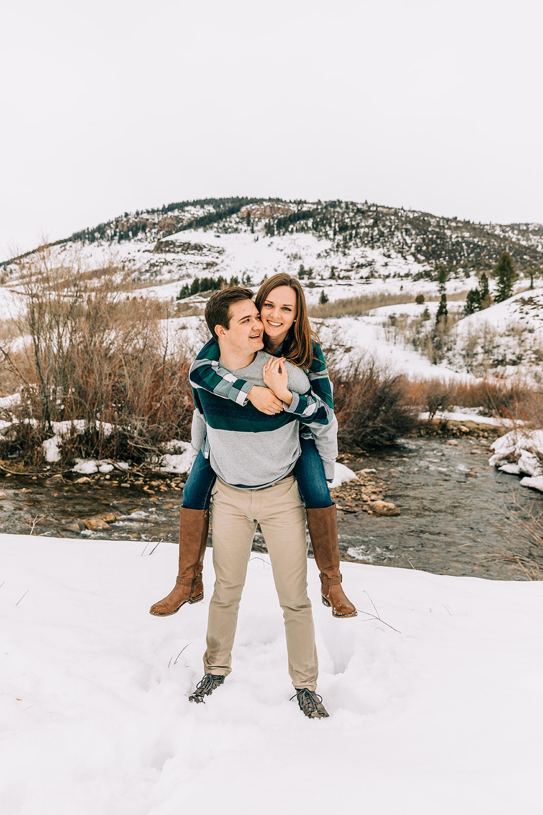  playful couple pose inspiration glowing couple happy couple logan canyon photo shoot session for newly engaged couple engagement session in the snow winter engagement session bella alder photography utah photographer winter outdoor photo shoot inspi