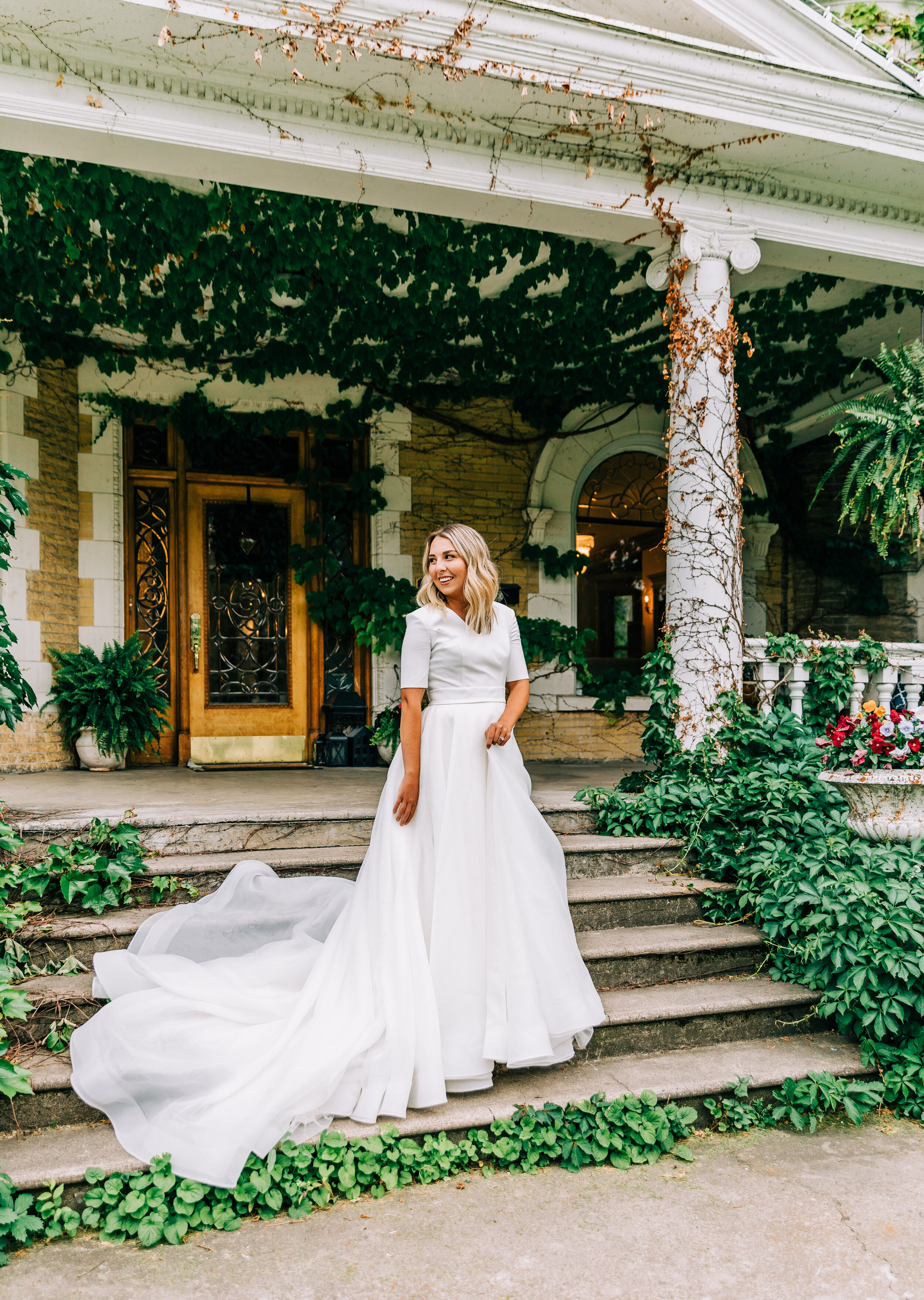  A romantic and beautiful bride gliding down Victorian steps in a gorgeous flowing Elizabeth Cooper Design wedding gown in Logan, Utah commercial photo shoot. Wedding goals bridal goals bridal aesthetic life goals photography goals wedding photo shoo