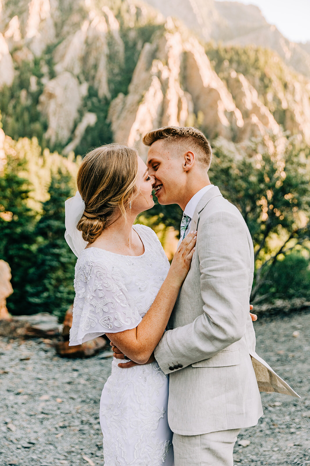  A couple kissing in the glowing Cottonwood Canyon of Salt Lake City, Utah. Bright and airy wedding photo shoot session kissing bride and groom wedding attire inspiration formal wedding session Bella Alder Photography professional Utah photographer c