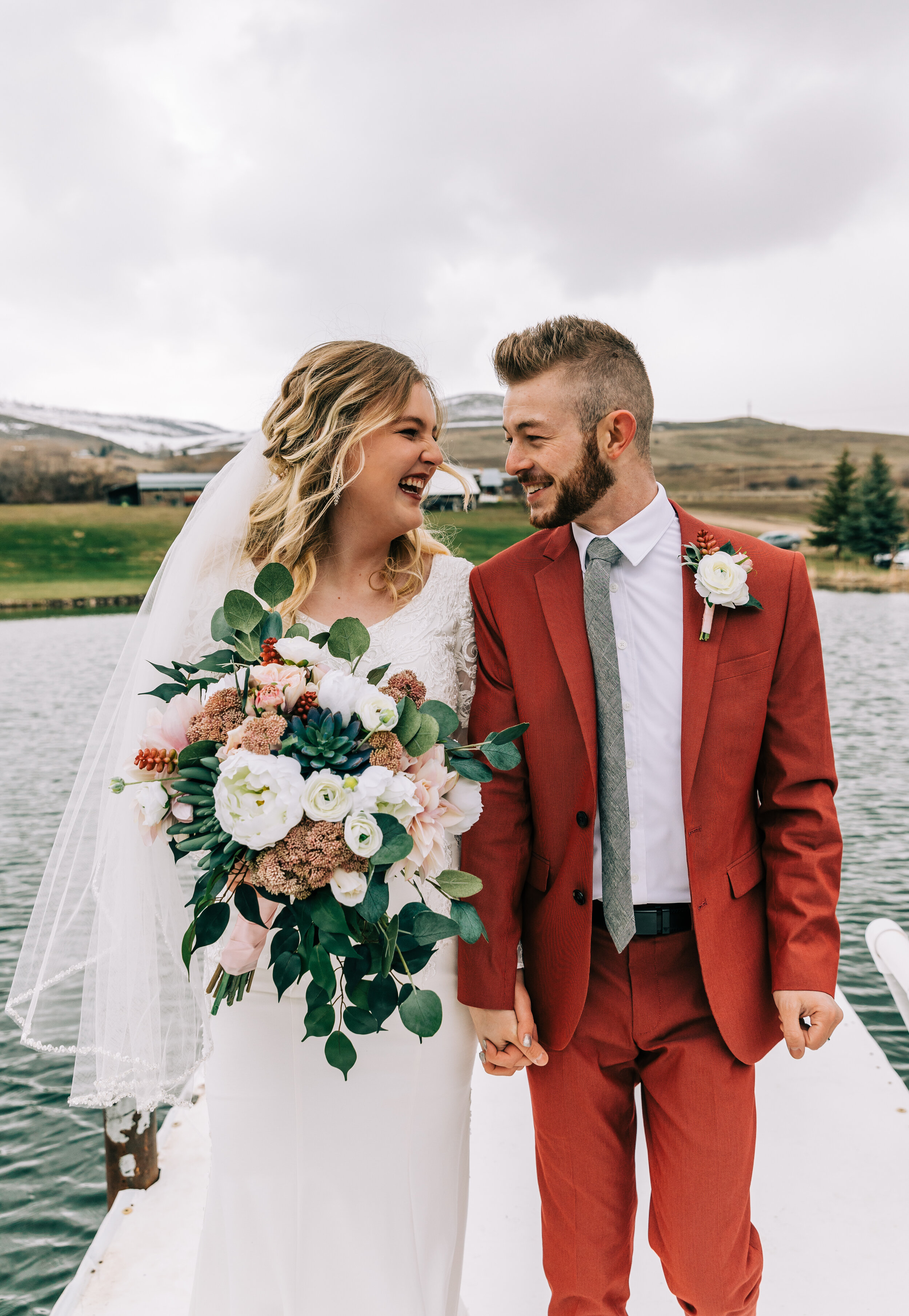  A couple standing on stormy waters in a beautiful outdoor elopement styled photo shoot in Preston, Idaho. Couple goals couple pose inspiration outdoor wedding elopement photographer unique rustic wedding aesthetic inspiration wedding goals Bella Ald
