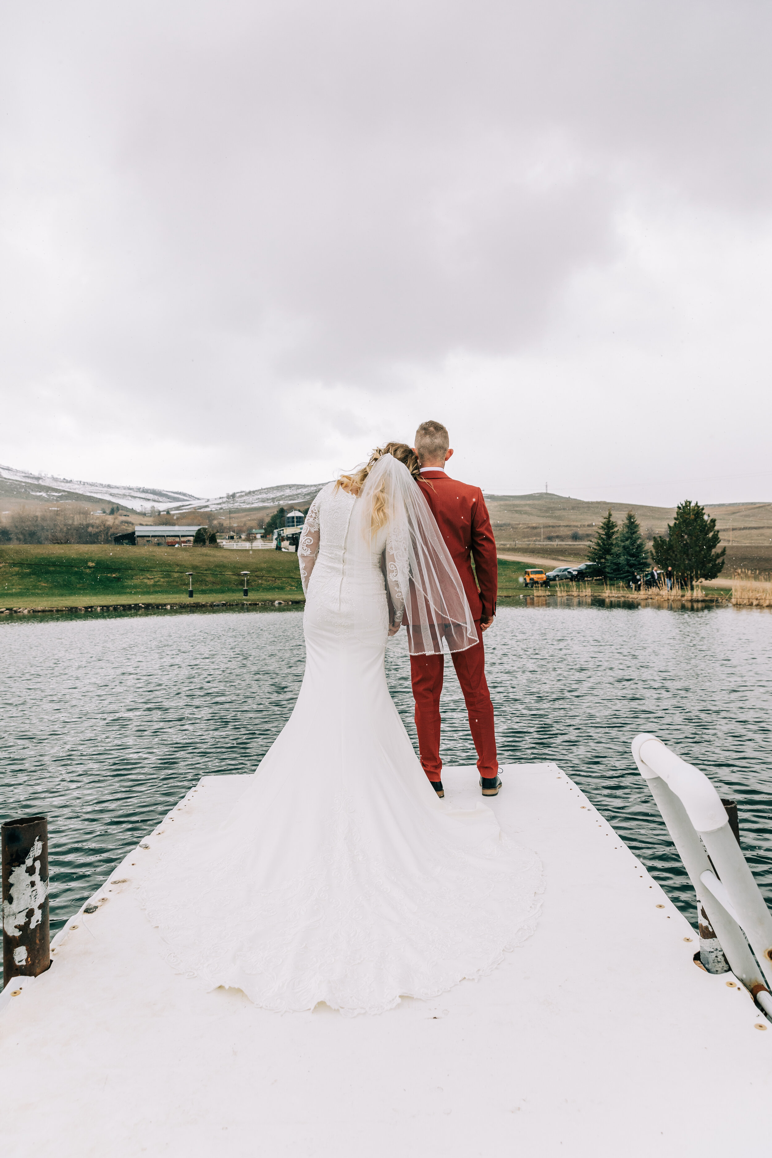  A beautiful couple standing alone looking out onto a beautiful stormy lake in a gorgeous rustic elopement styled photo shoot. Couple pose goals couple goals wedding goals outdoor wedding photo shoot inspiration Preston, Idaho goals professional elop