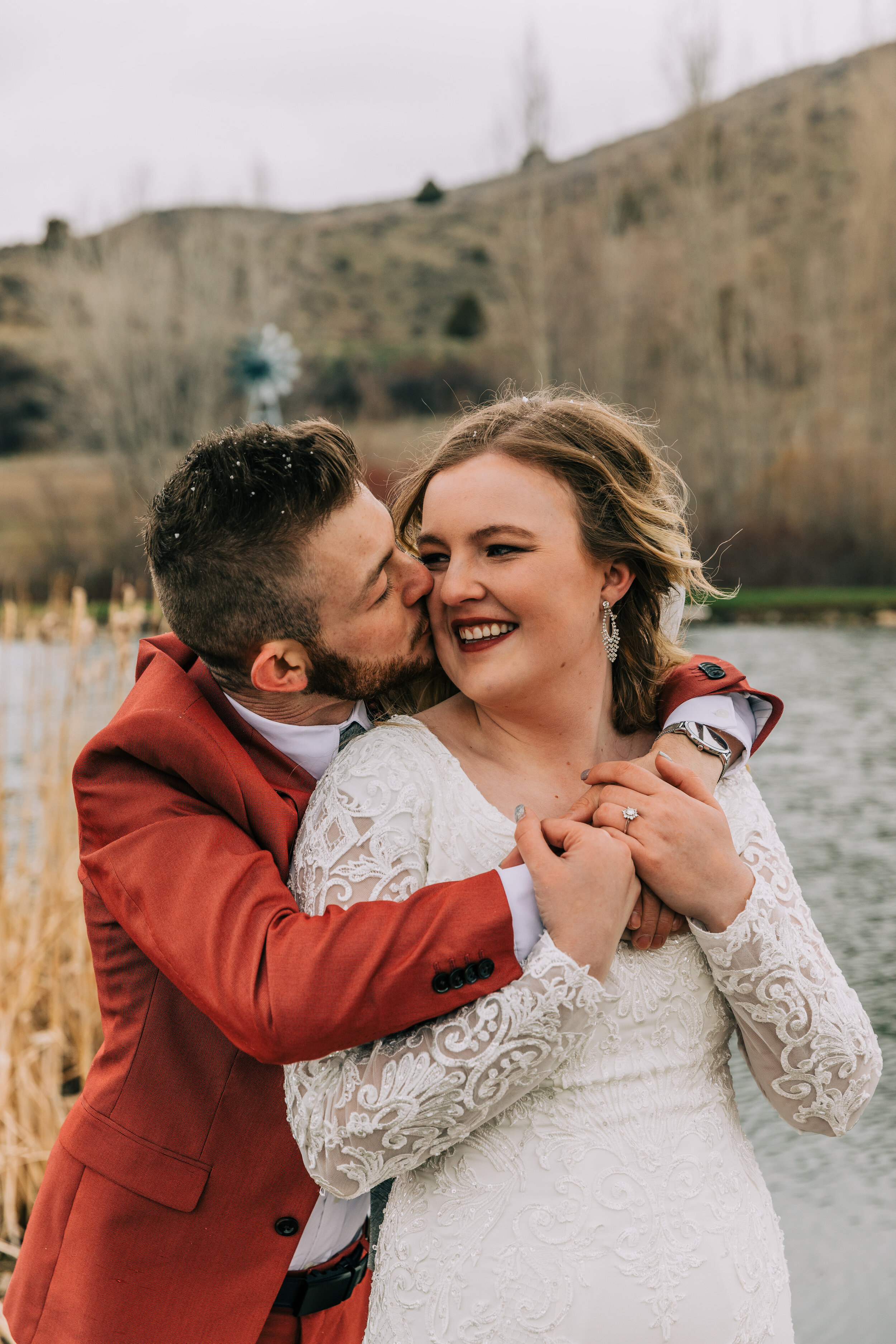  A groom hugging and kissing his bride in a romantic chic and rustic elopement styled photo shoot. Bella Alder Photography elopement goals elopement styled photo shoot inspiration couple goals outdoor wedding inspiration ideas and goals couple pose i