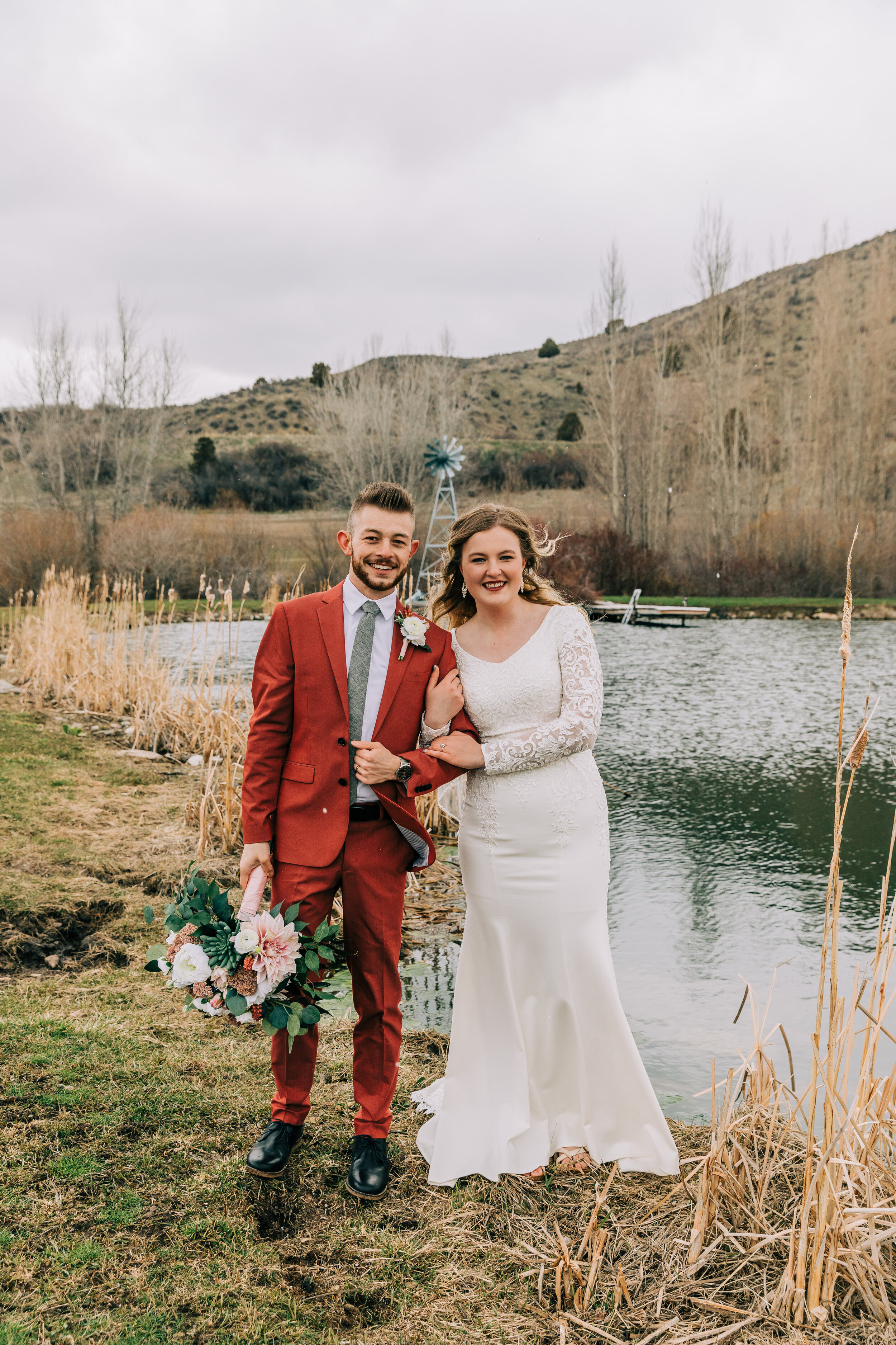  A gorgeous bride and groom standing on the banks of a gorgeous lake in a fall styled wedding session. Preston, Idaho photography elopement photographer couple goals wedding aesthetic inspiration wedding goals groom attire inspiration unique groom ae